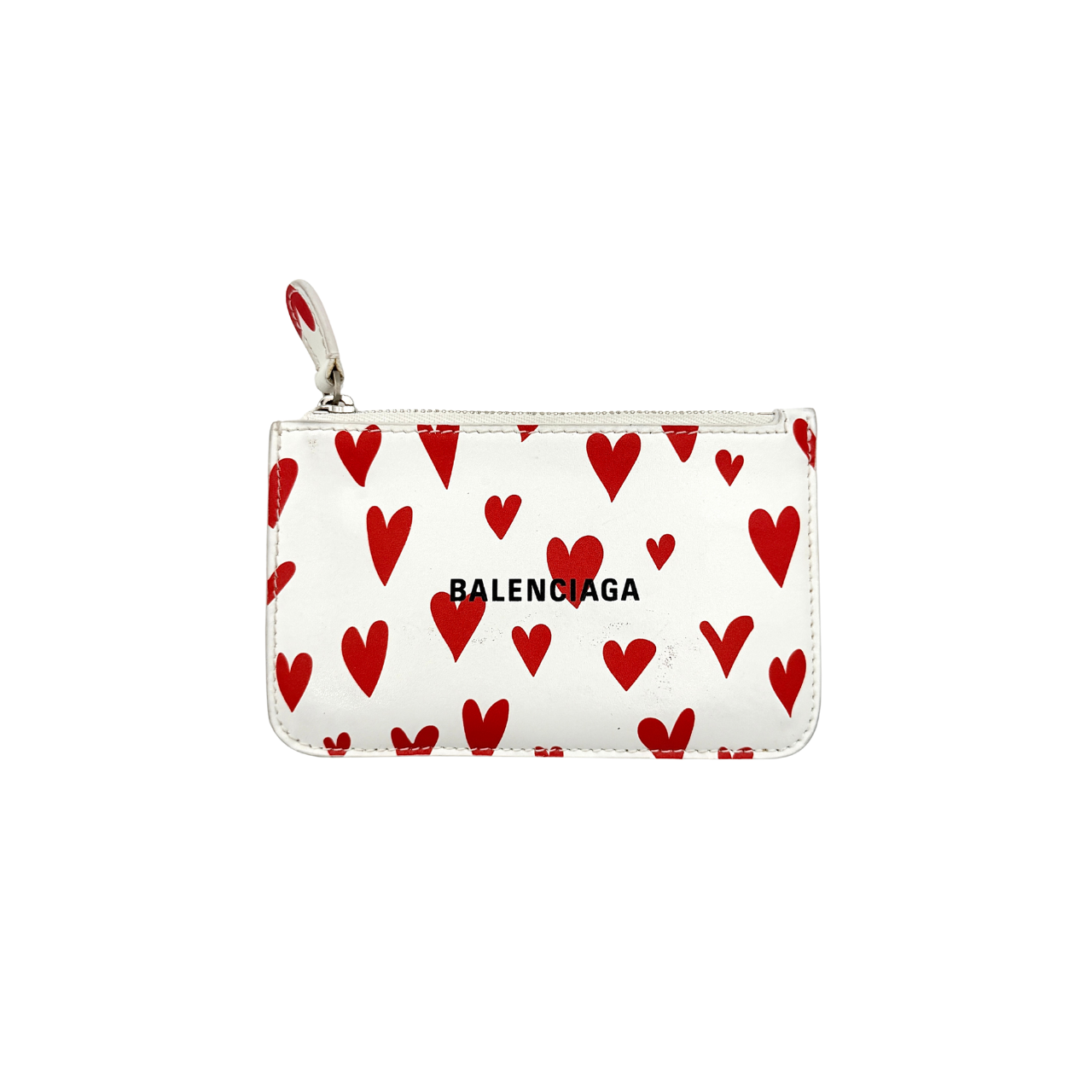 Balenciaga white leather card holder with playful red hearts and zip closure, set against a clean background.