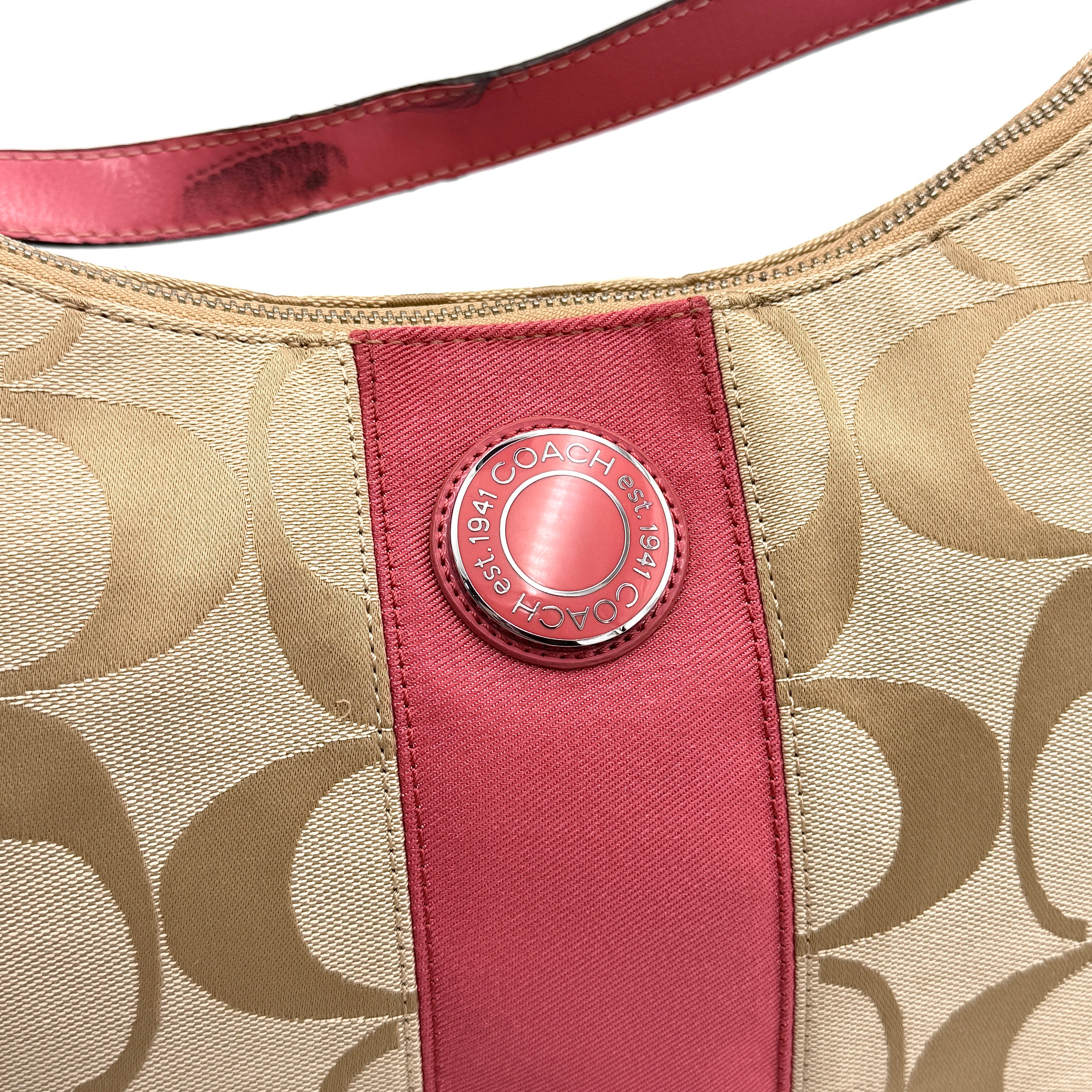 Coach Signature Stripe Hobo Shoulder Bag in beige jacquard canvas with bold pink central stripe and pink leather shoulder strap.