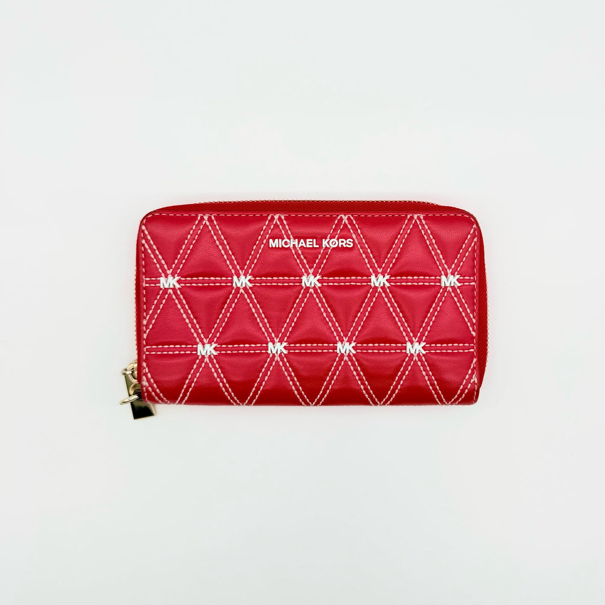 Front view of the Michael Kors red quilted large wallet with gold zip and MK monogram stitching.