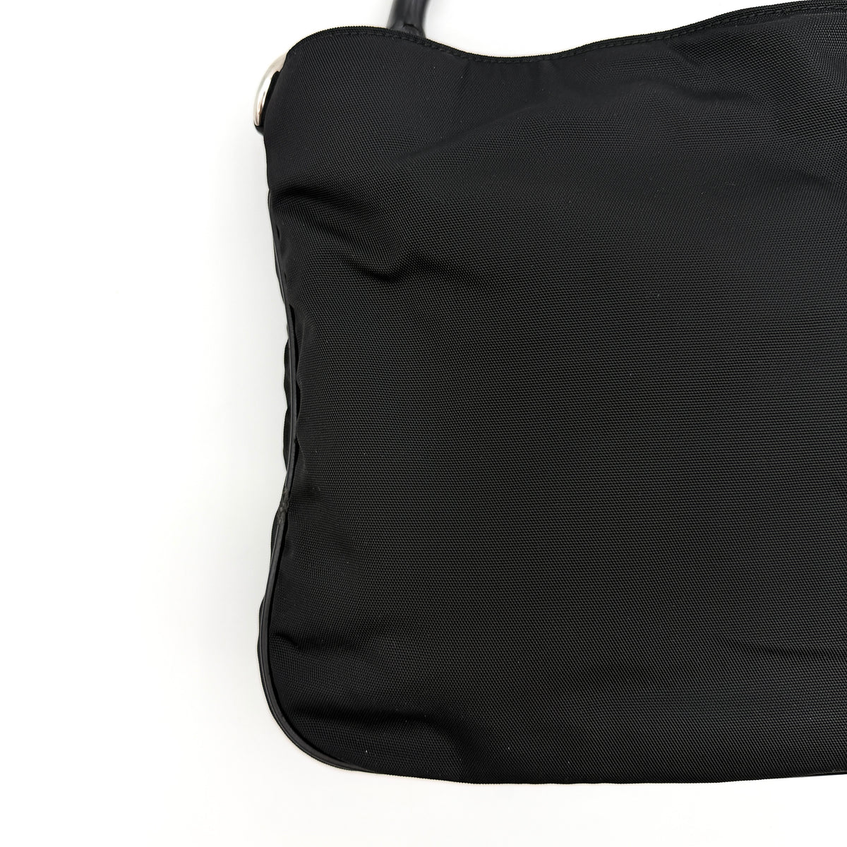 Gucci black nylon shoulder bag with bamboo handle and detachable strap shown with dust bag.