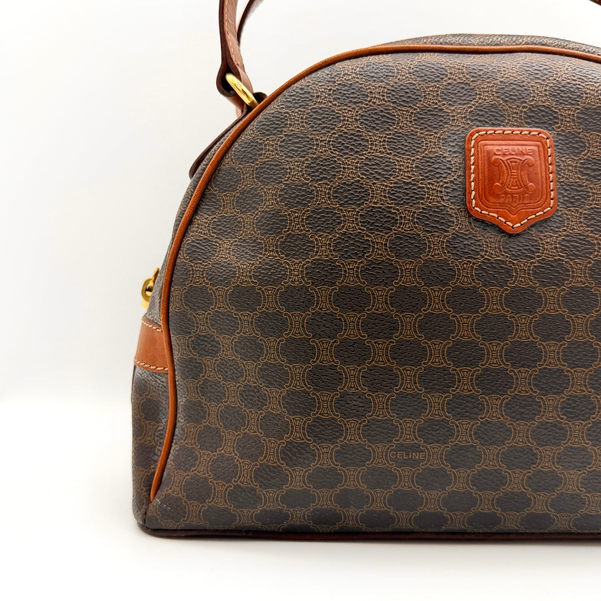 Front view of the Celine Triomphe Macadam Dome Handbag in brown, featuring the signature monogram canvas and tan leather details.