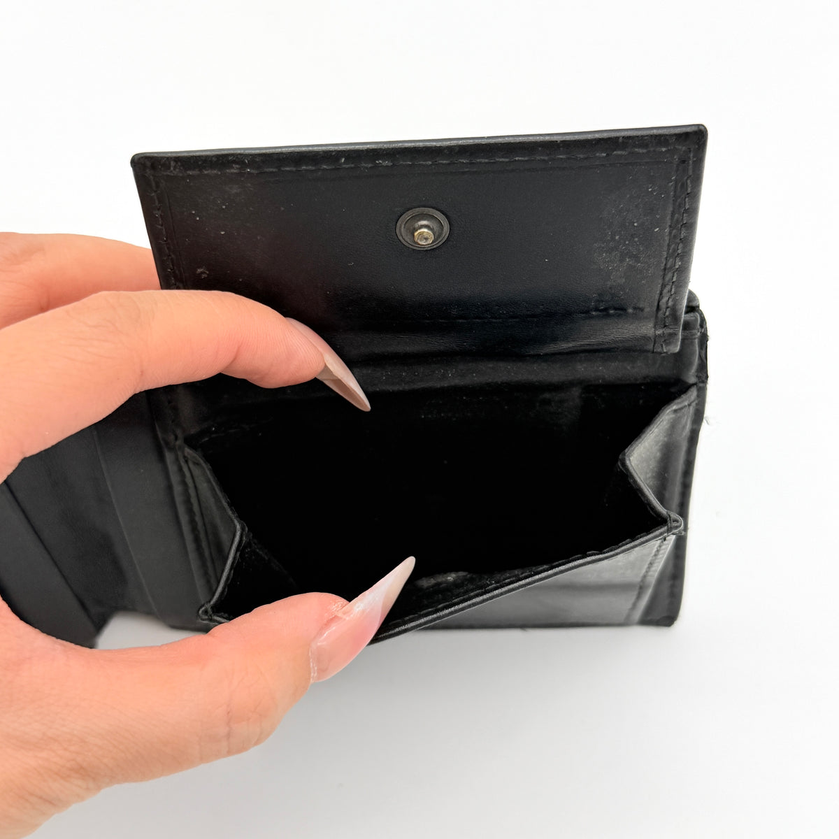 Bottega Veneta black Intrecciato woven leather wallet, shown closed against a white background.