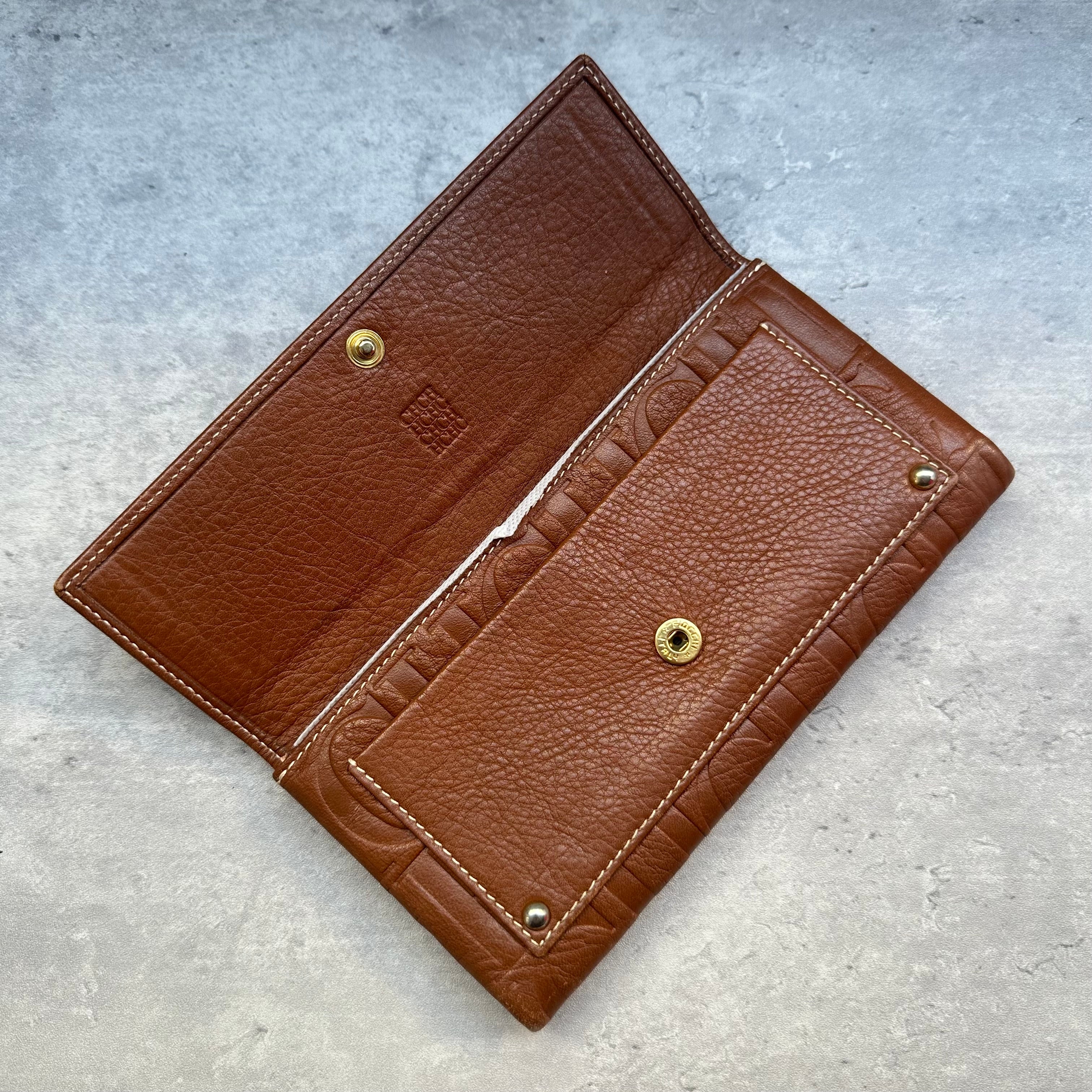 Carolina Herrera brown wallet open showing inner flap and snap closure