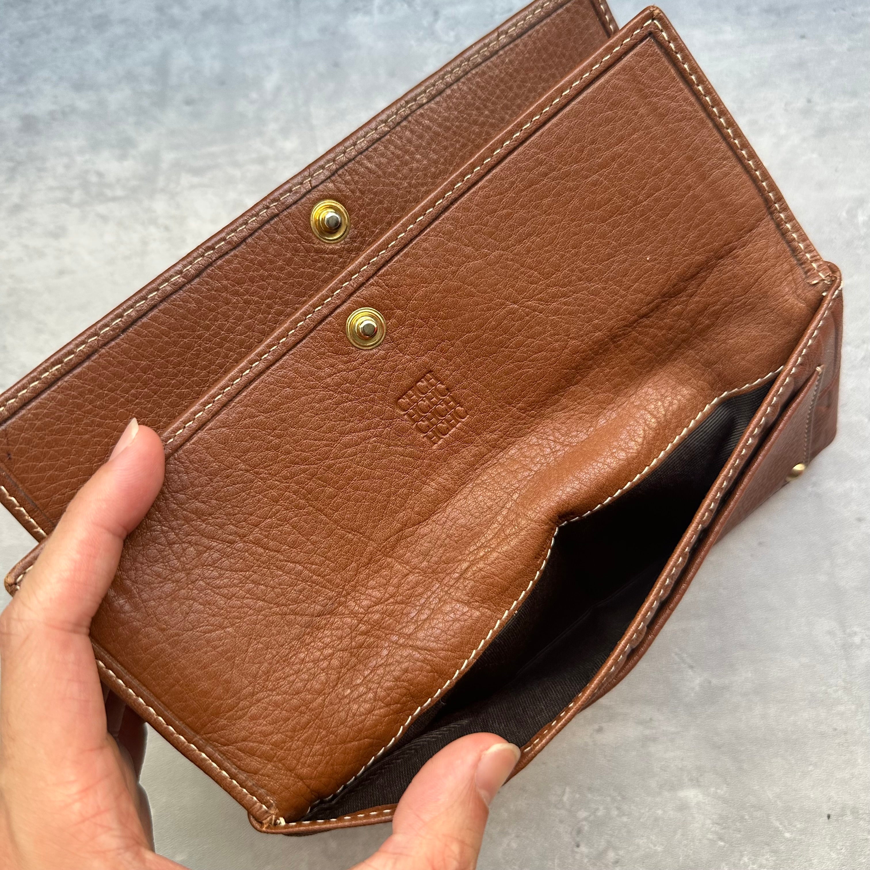 Detail of Carolina Herrera wallet exterior flap pocket and interior logo stamp