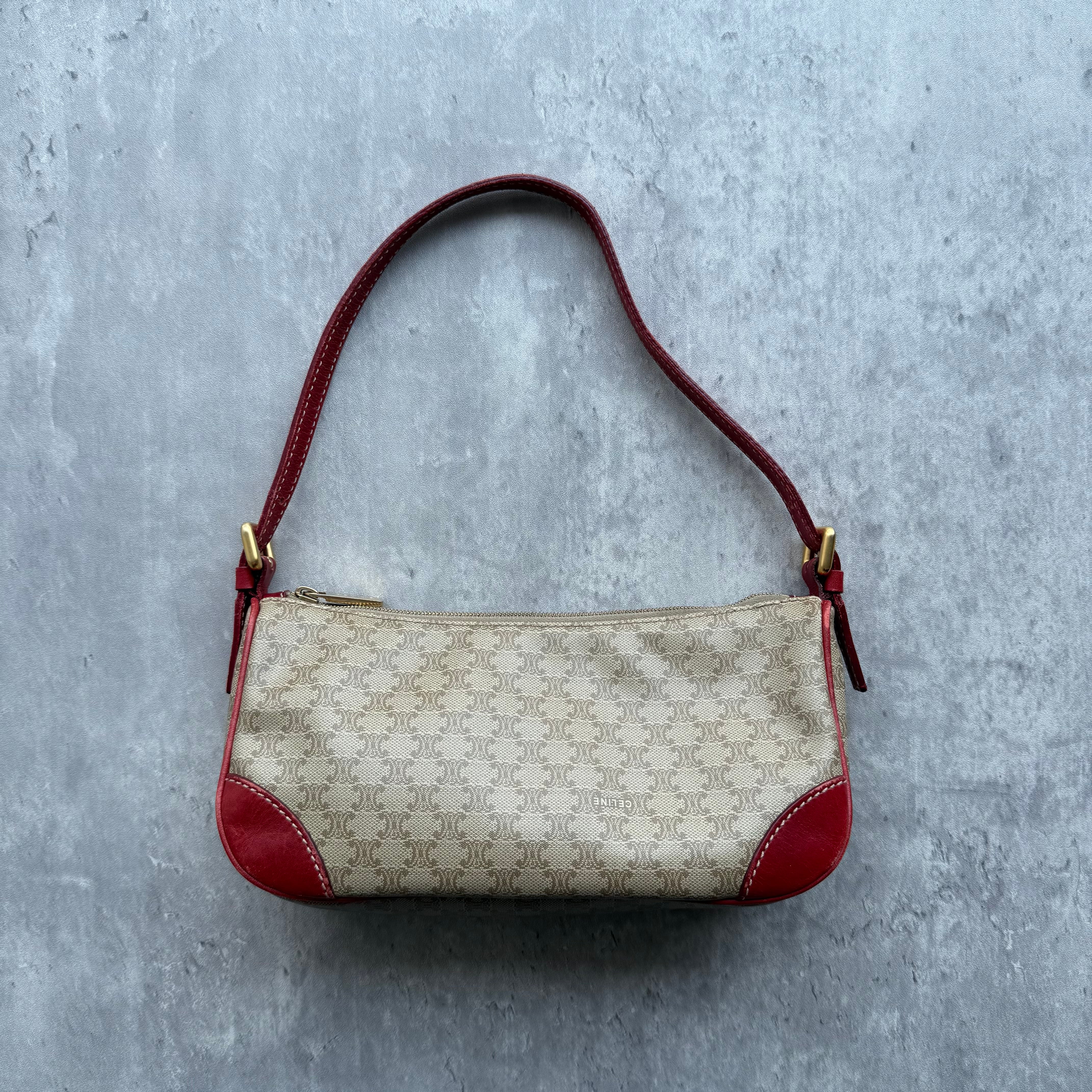 Celine Macadam Canvas Shoulder Bag in Beige with red leather trim and strap, gold-tone hardware, and zip closure.