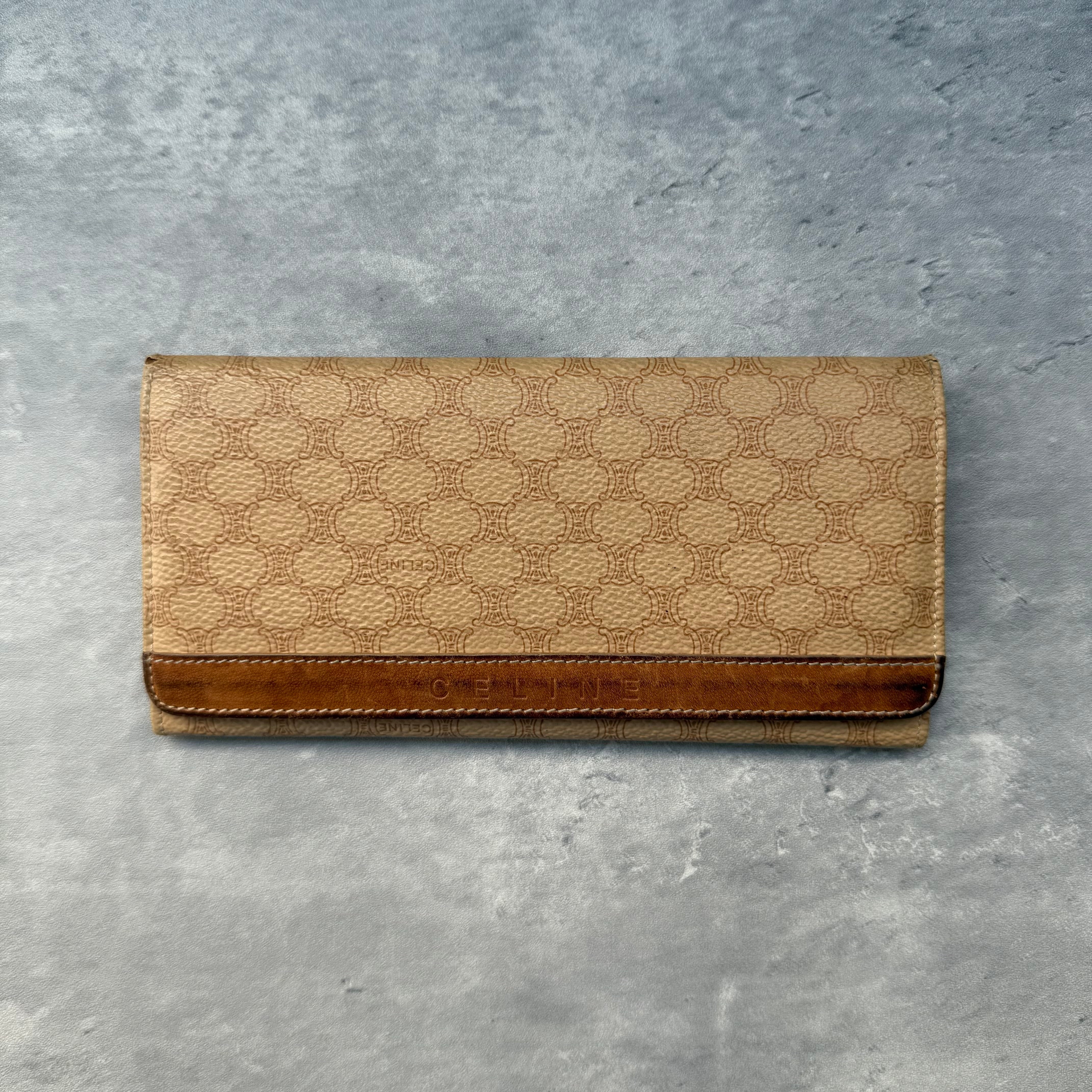 Celine Macadam Long Wallet Beige, crafted in signature Macadam coated canvas with brown leather trim, featuring multiple card slots and a zippered compartment.