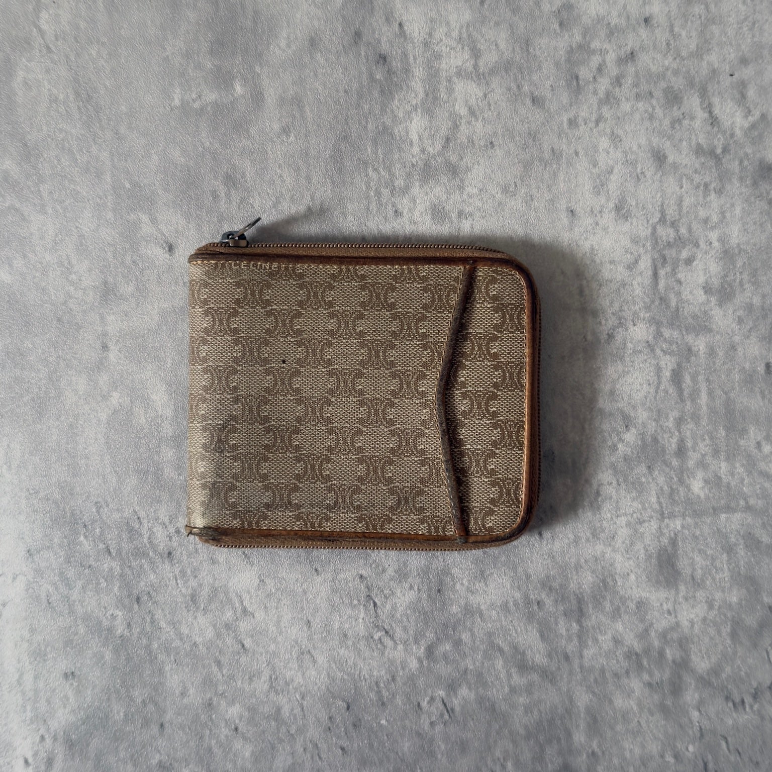 Celine Signature Macadam Triomphe Wallet in beige canvas with brown leather details, featuring multiple organizational compartments, embodying classic elegance and functionality.