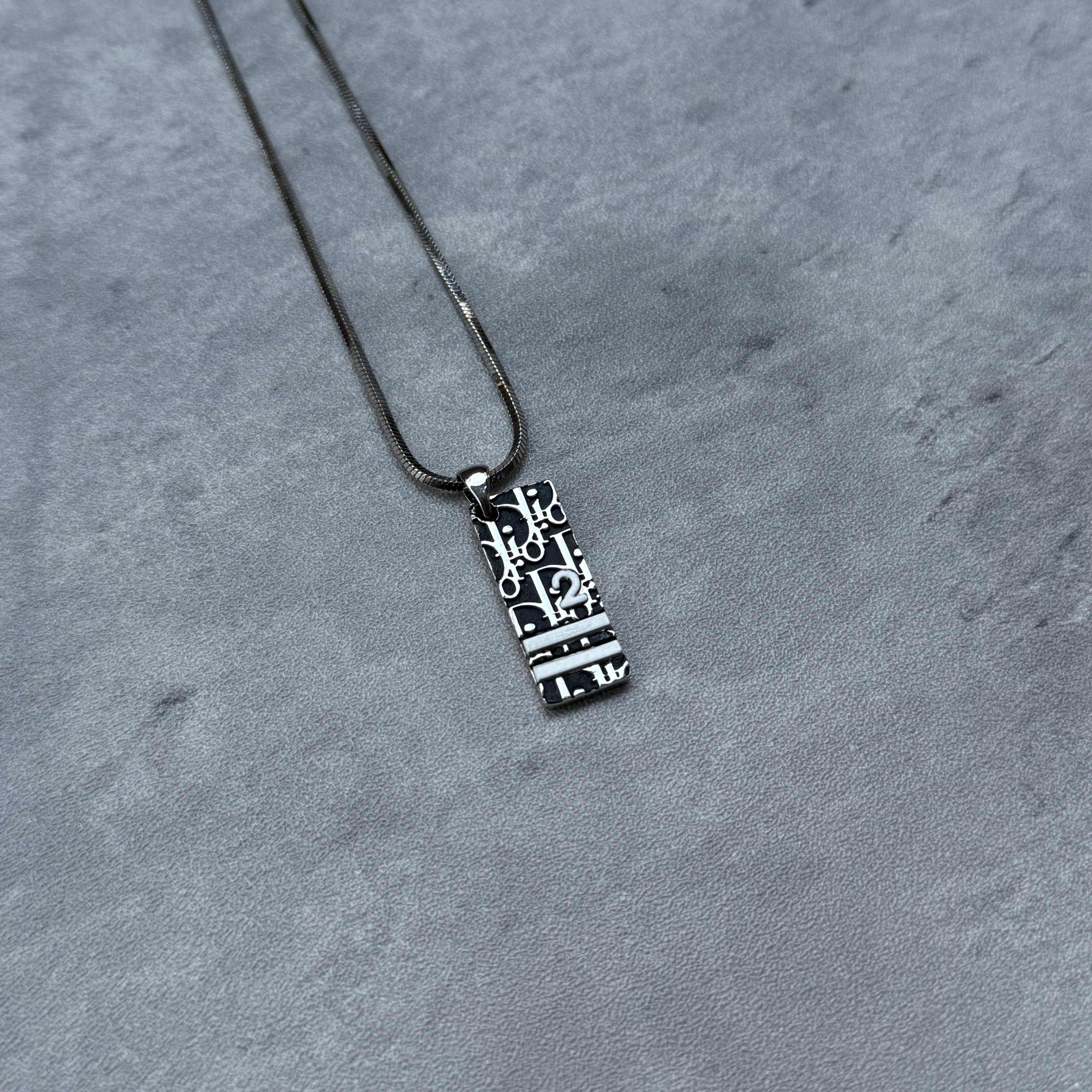 Christian Dior Y2K Trotter Pendant Necklace Black, featuring rectangular pendant with Dior logo motif on silver chain.