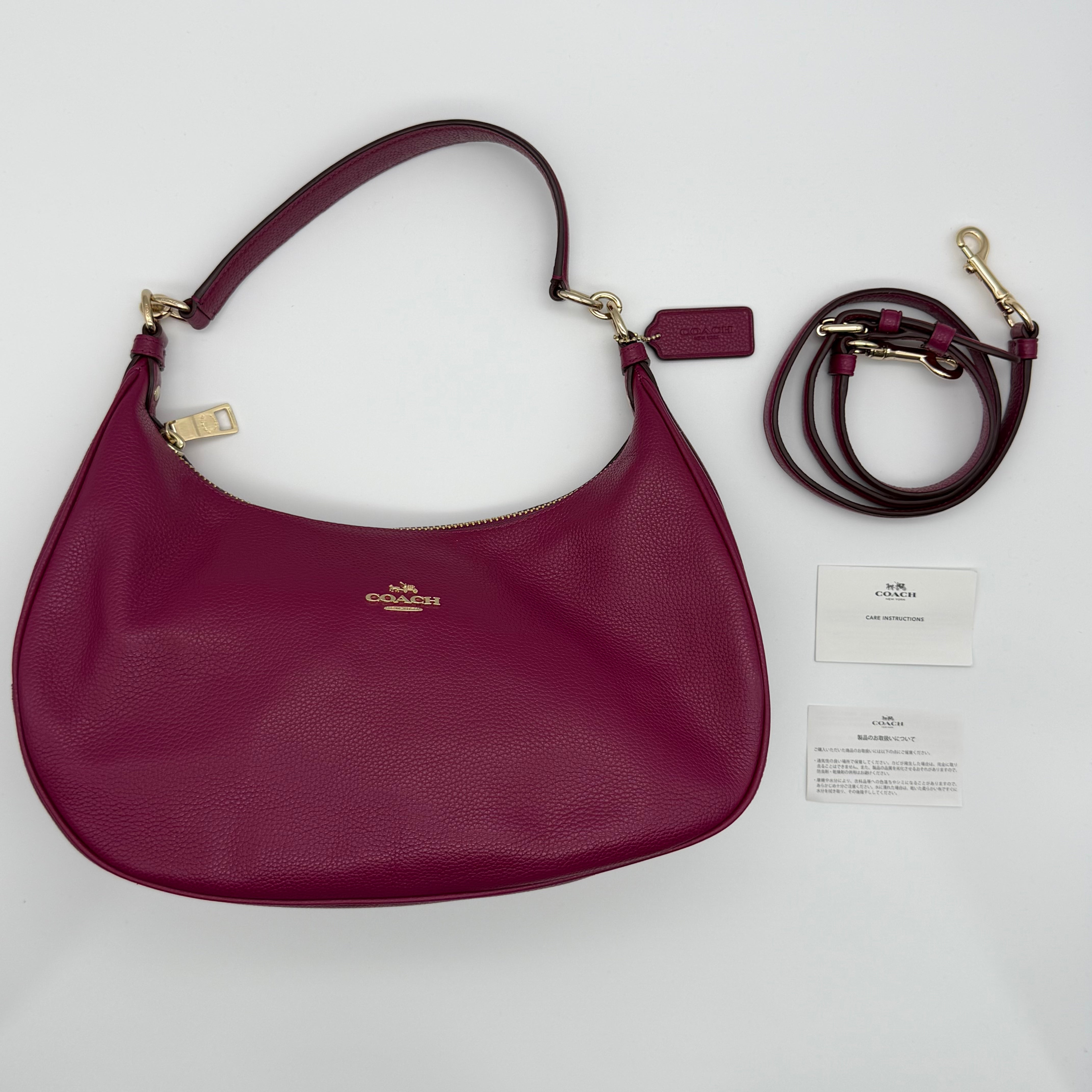 Coach 2-Way leather hobo shoulder bag in berry pink with gold hardware, back zip pocket and detachable strap — pre-loved.