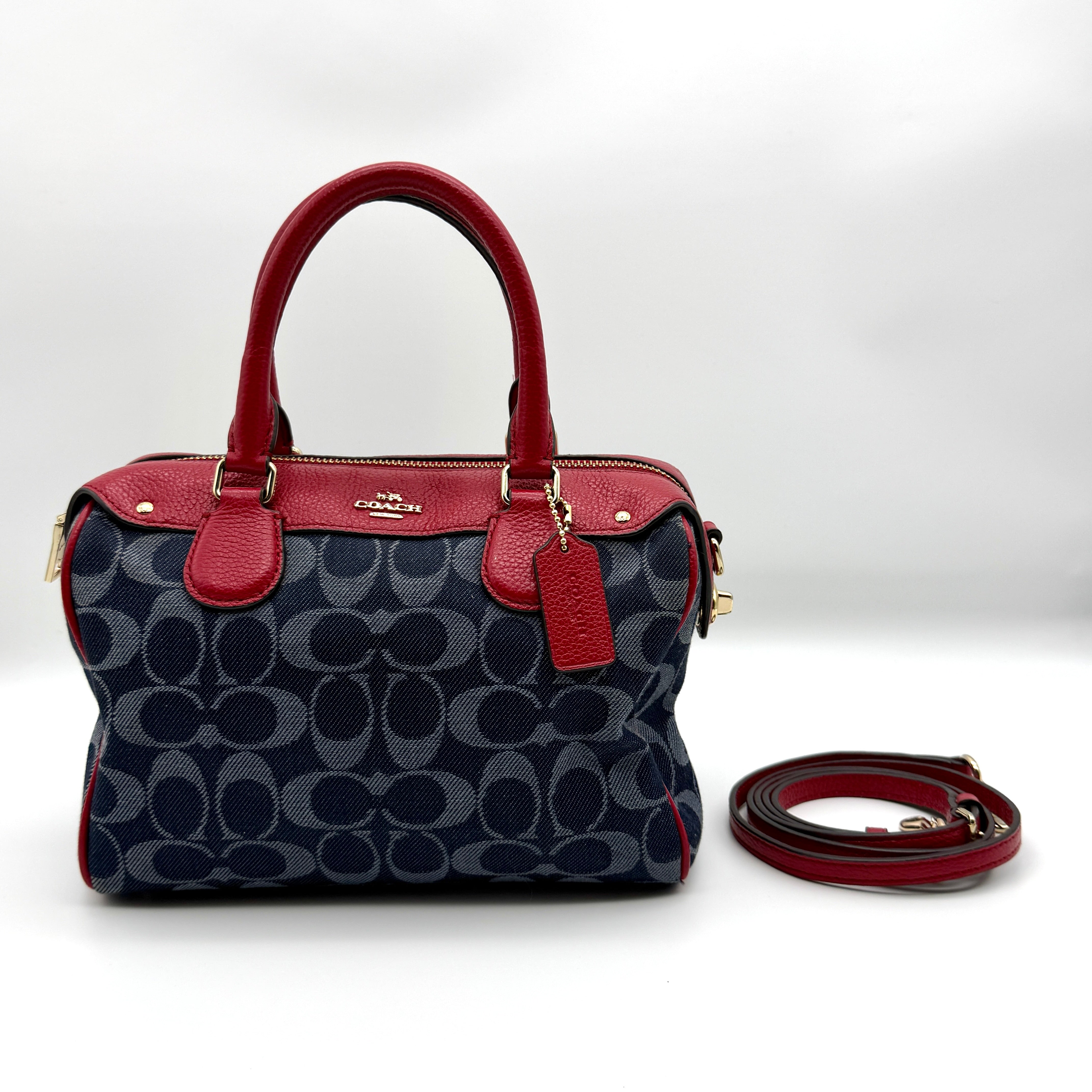 Coach Mini Bennett Boston in blue Signature jacquard with red leather trim, gold hardware, and detachable strap — pre-loved.