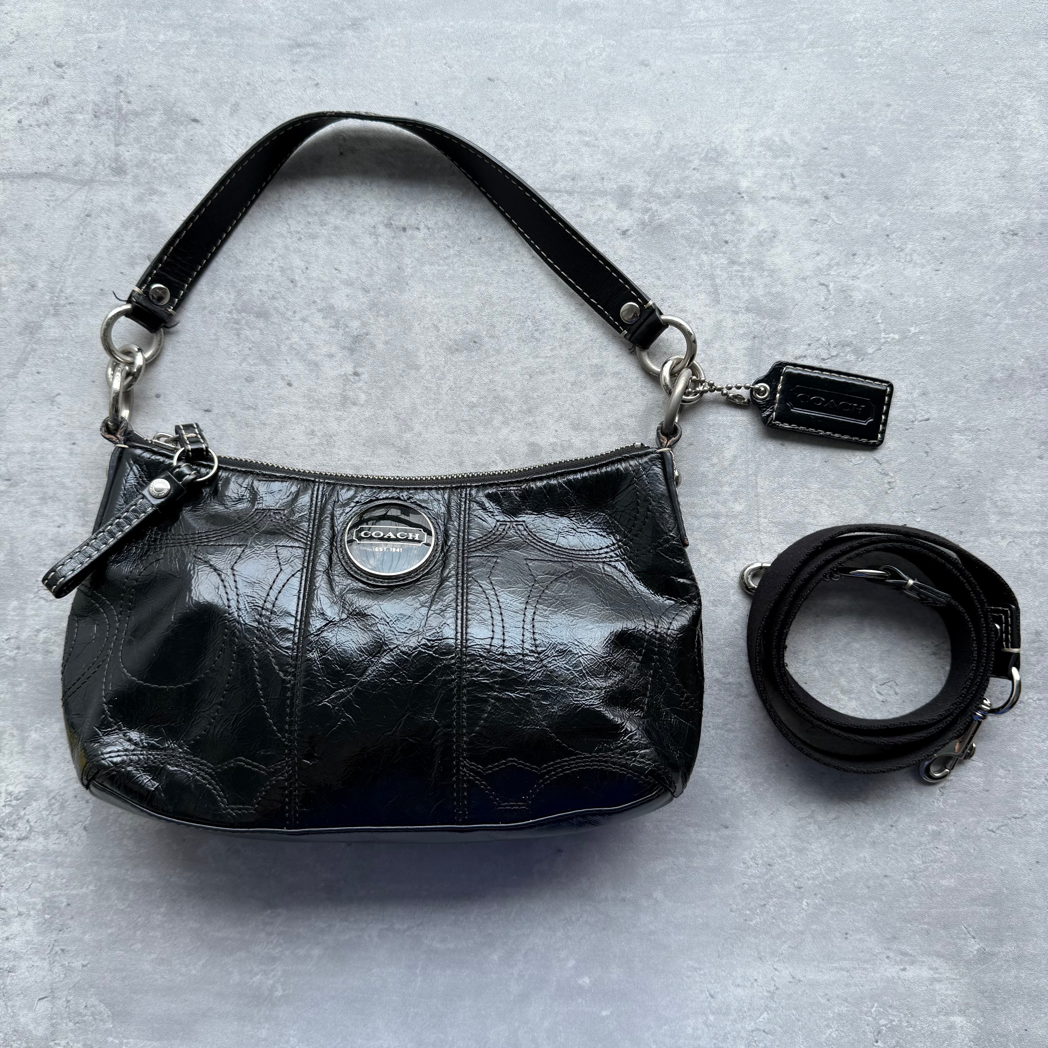 Coach 2Way Signature Patent Leather Shoulder Bag in black with embossed monogram, silver-tone hardware, detachable crossbody strap, and light blue satin lining.