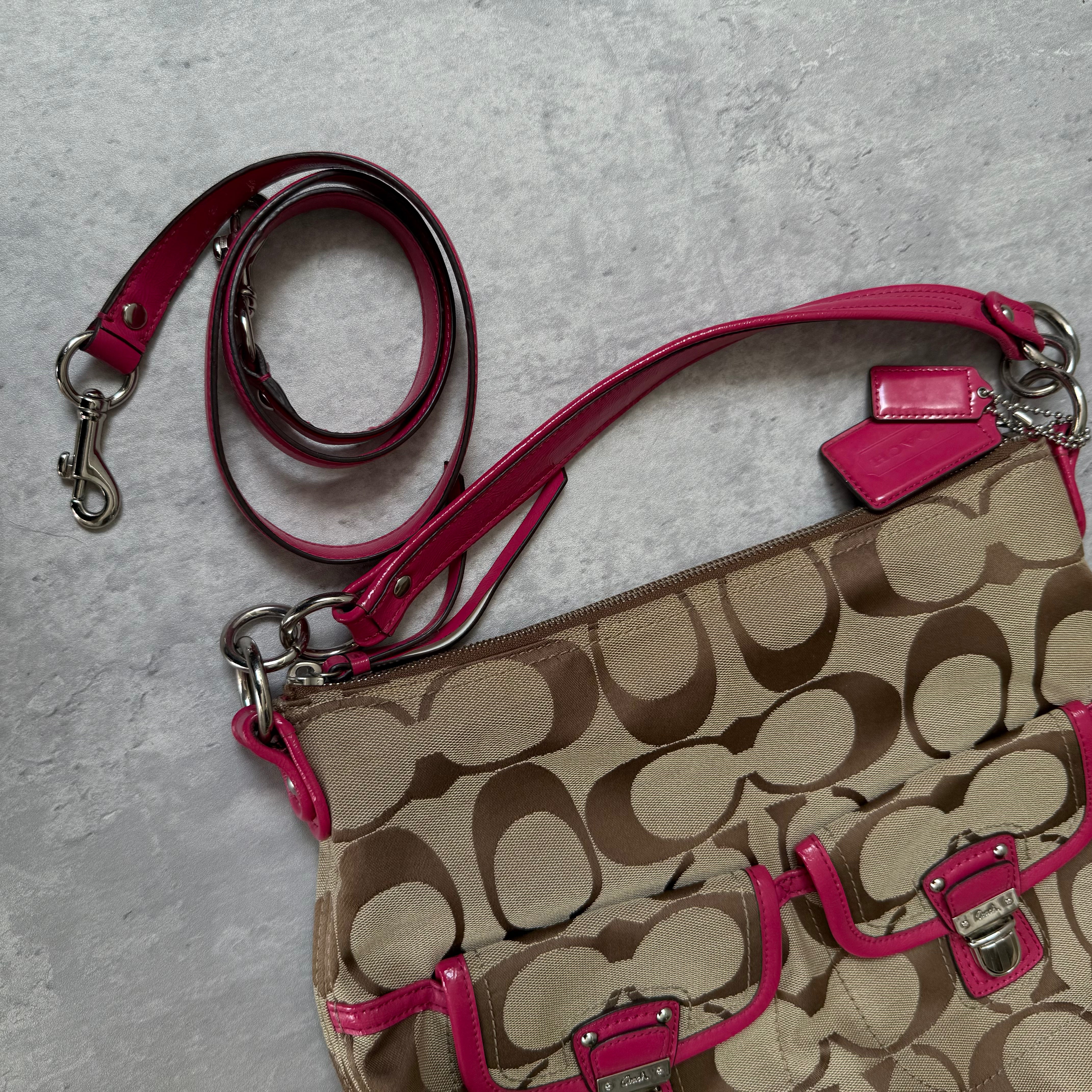 Coach 2Way Signature Pocket Hobo Daisy Bag in beige canvas with pink leather trim, dual front pockets, and detachable strap.