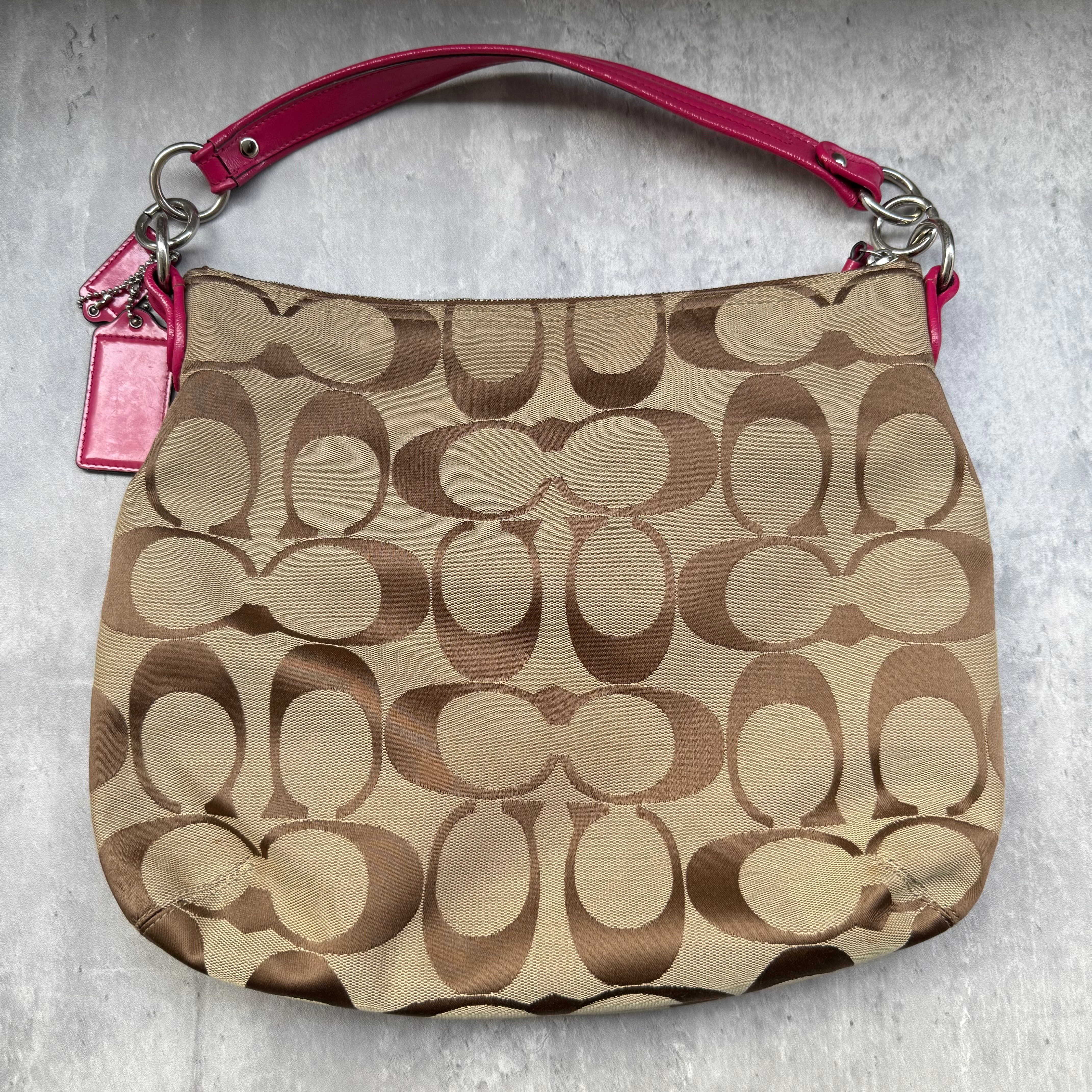 Coach 2Way Signature Pocket Hobo Daisy Bag in beige canvas with pink leather trim, dual front pockets, and detachable strap.