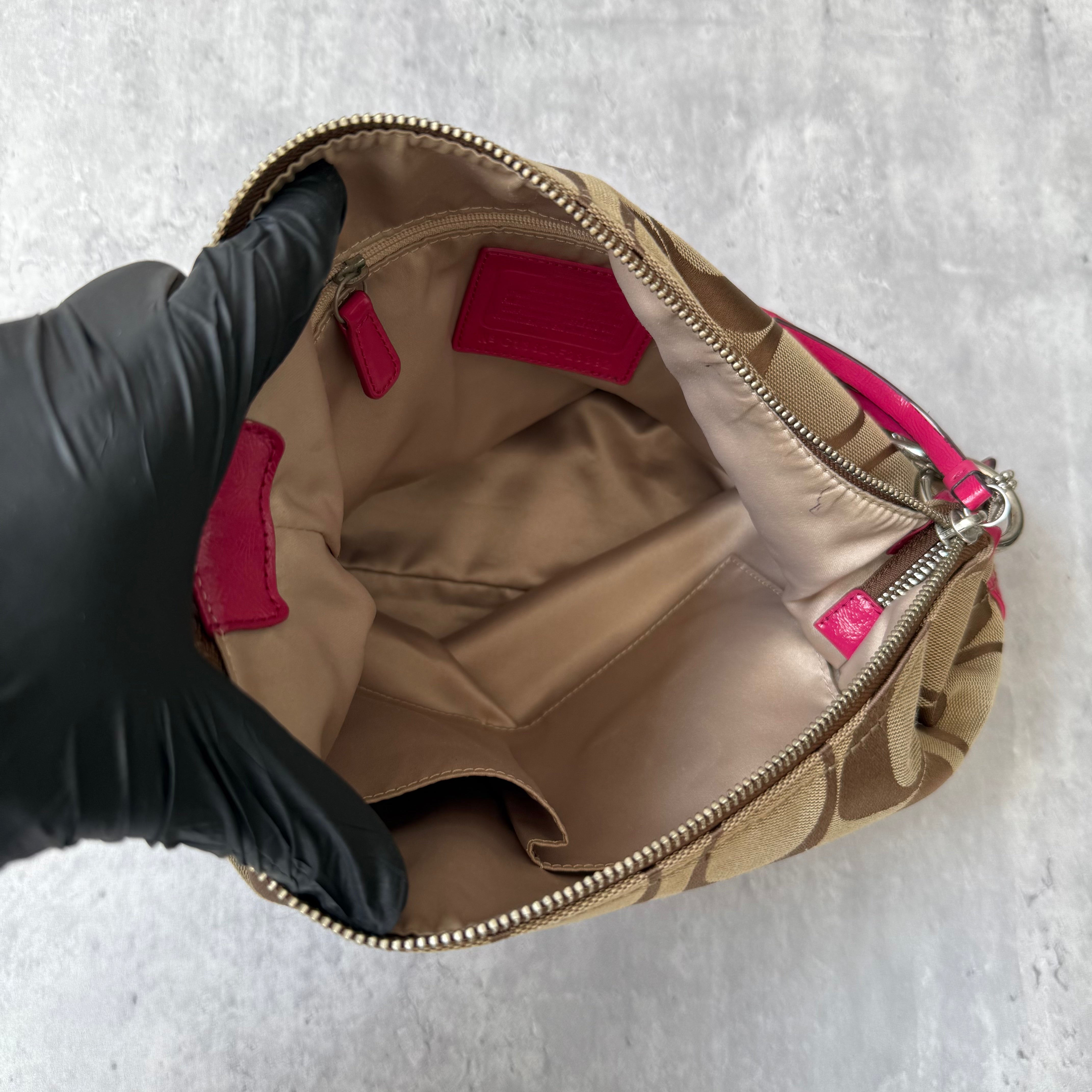 Coach 2Way Signature Pocket Hobo Daisy Bag in beige canvas with pink leather trim, dual front pockets, and detachable strap.