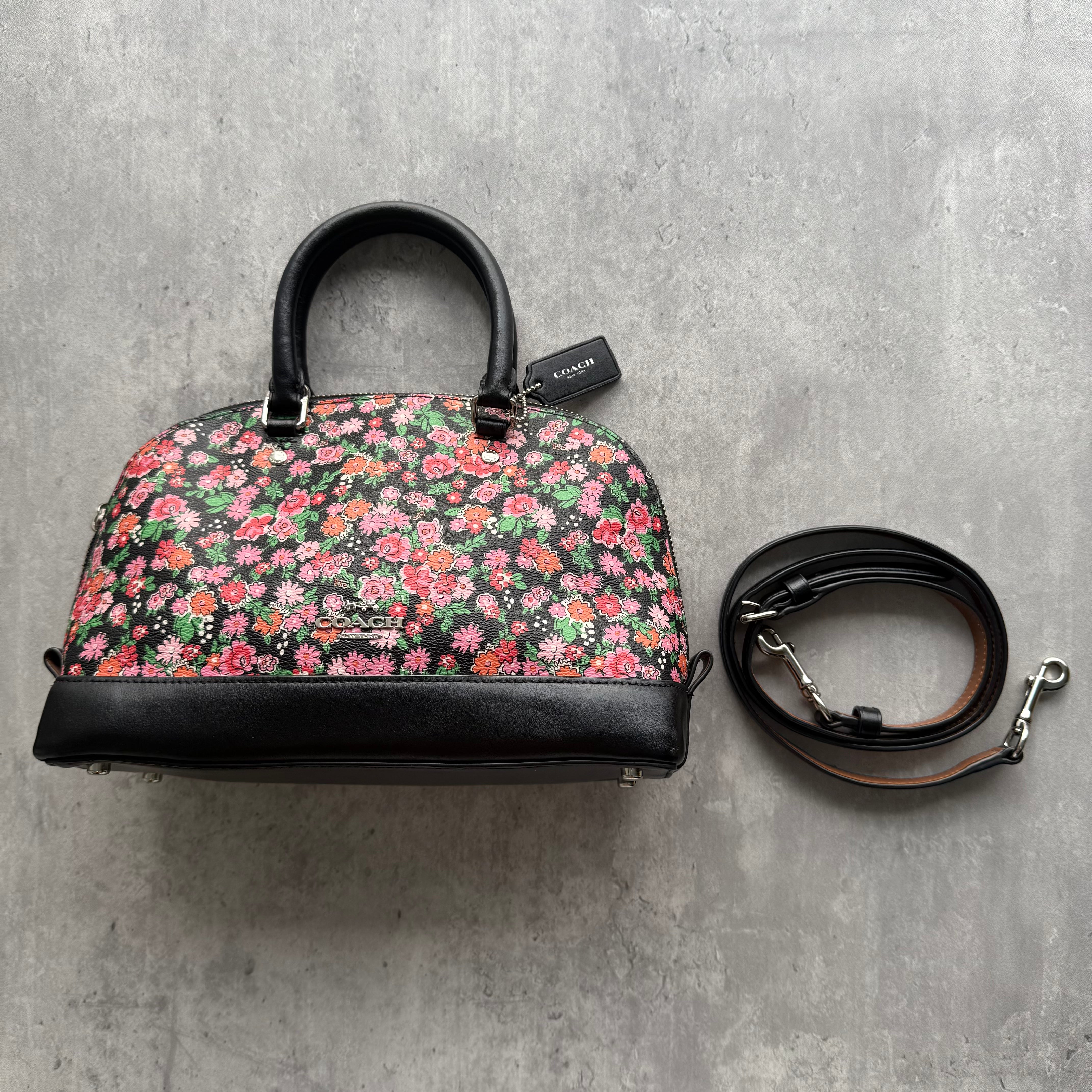 Coach 2Way Signature Sierra Floral Handbag in multicolor floral canvas with black leather trim and detachable strap.