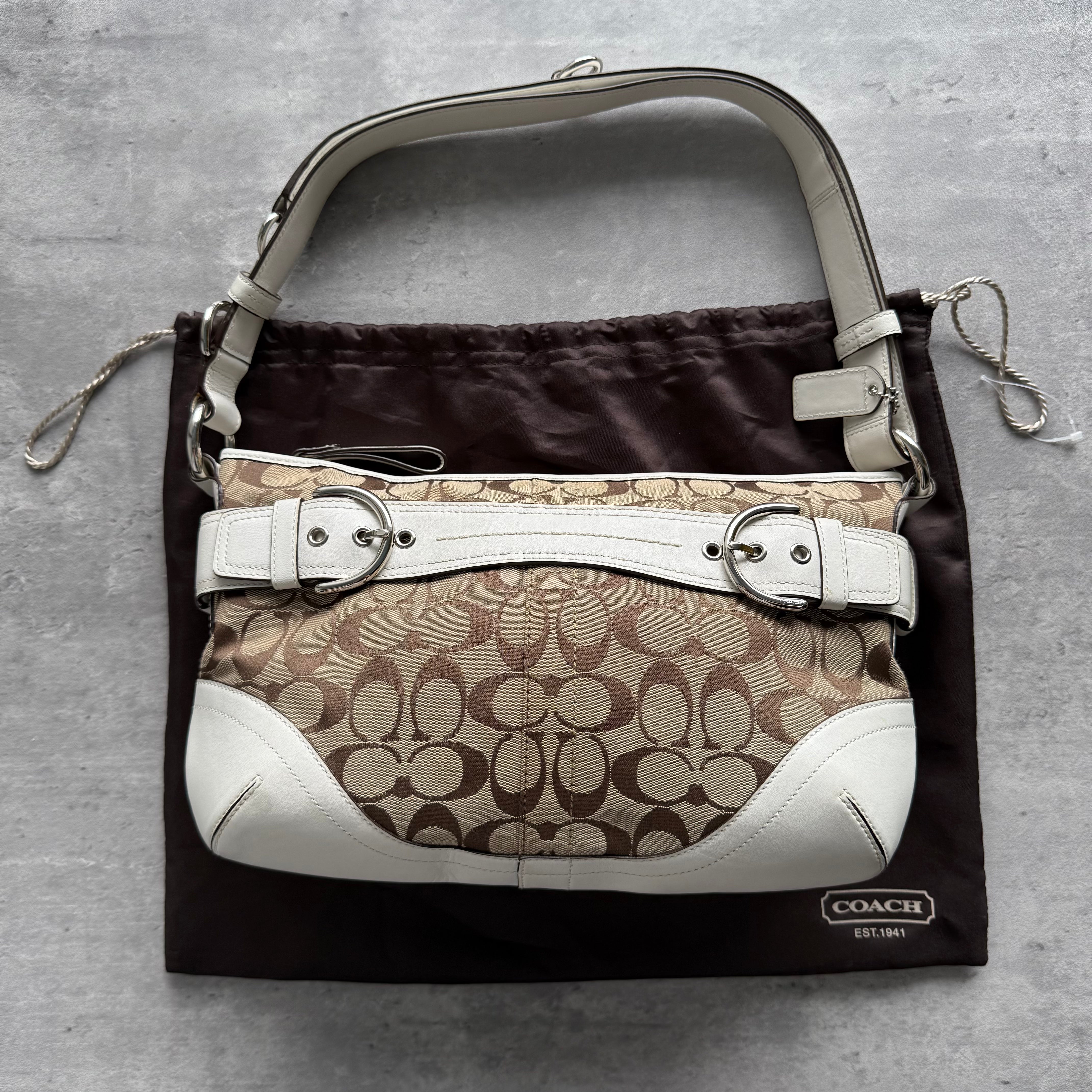 Coach 2Way Signature Sufflette Shoulder Bag in beige and white, crafted from jacquard canvas with leather trim, silver-tone buckle accents, and original dust bag.