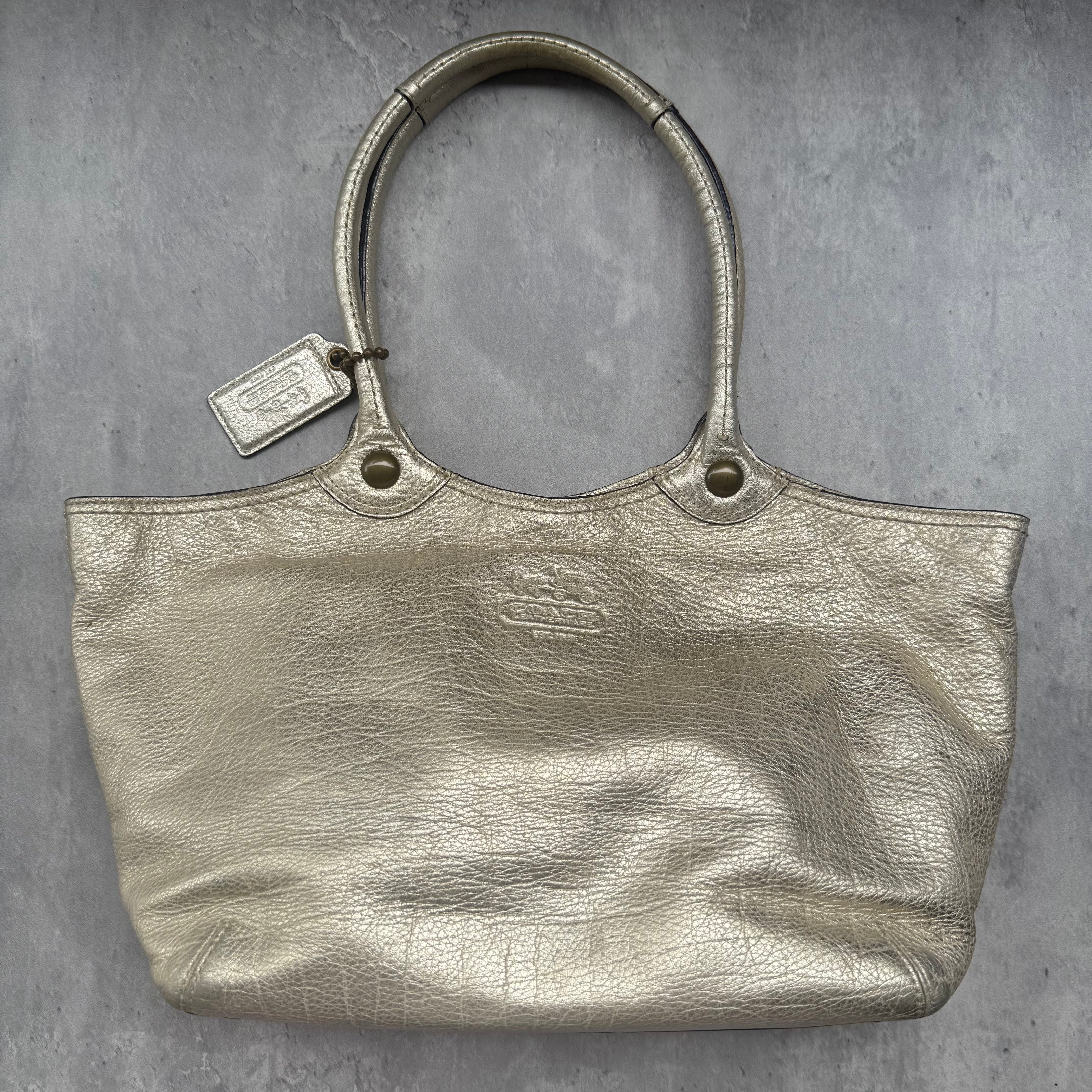 Coach Bleecker Platinum Metallic Tote Bag in light gold leather with plaid interior and gold-tone hardware.