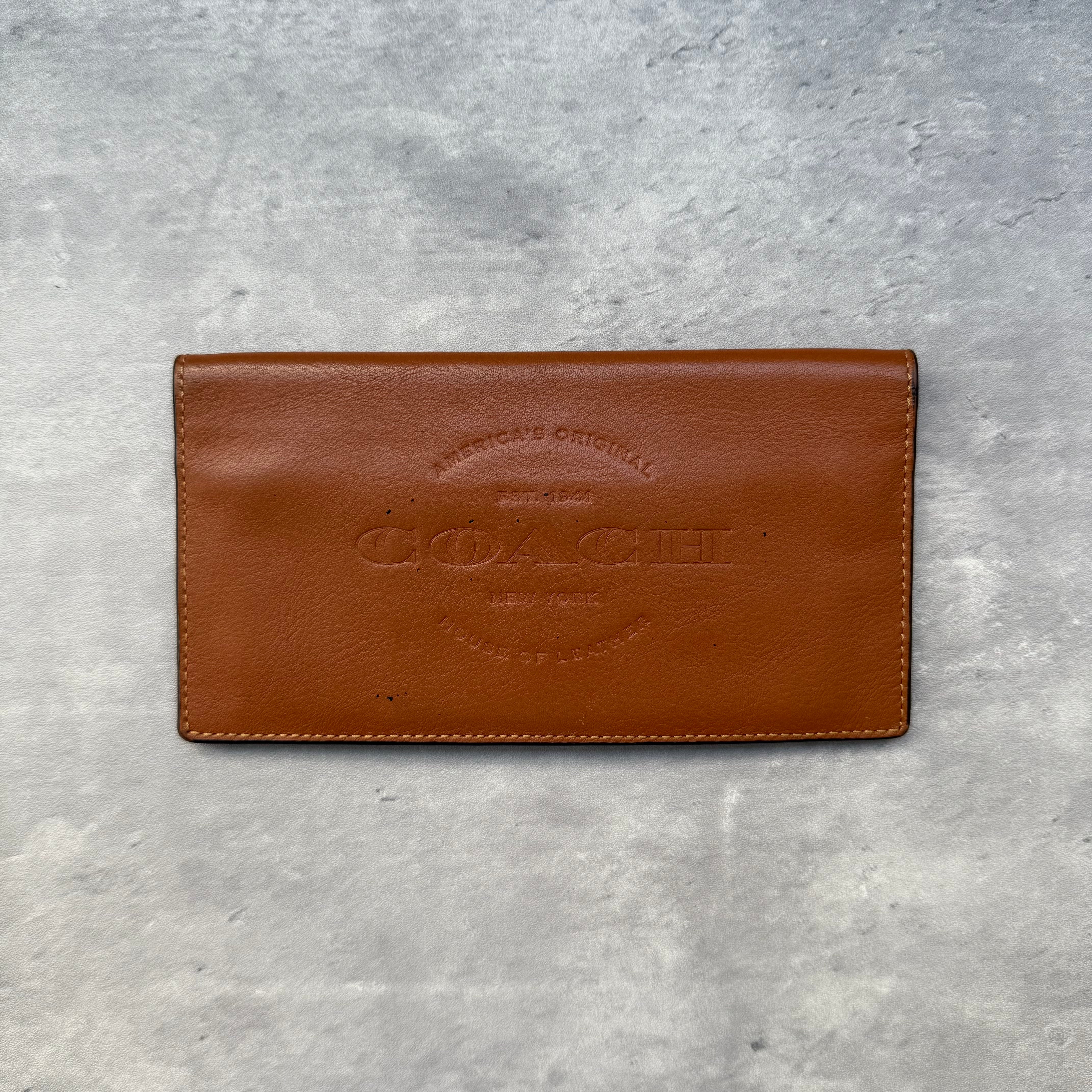 Coach Breast Pocket Wallet Brown, crafted in smooth leather with embossed Coach logo and multiple interior card slots.