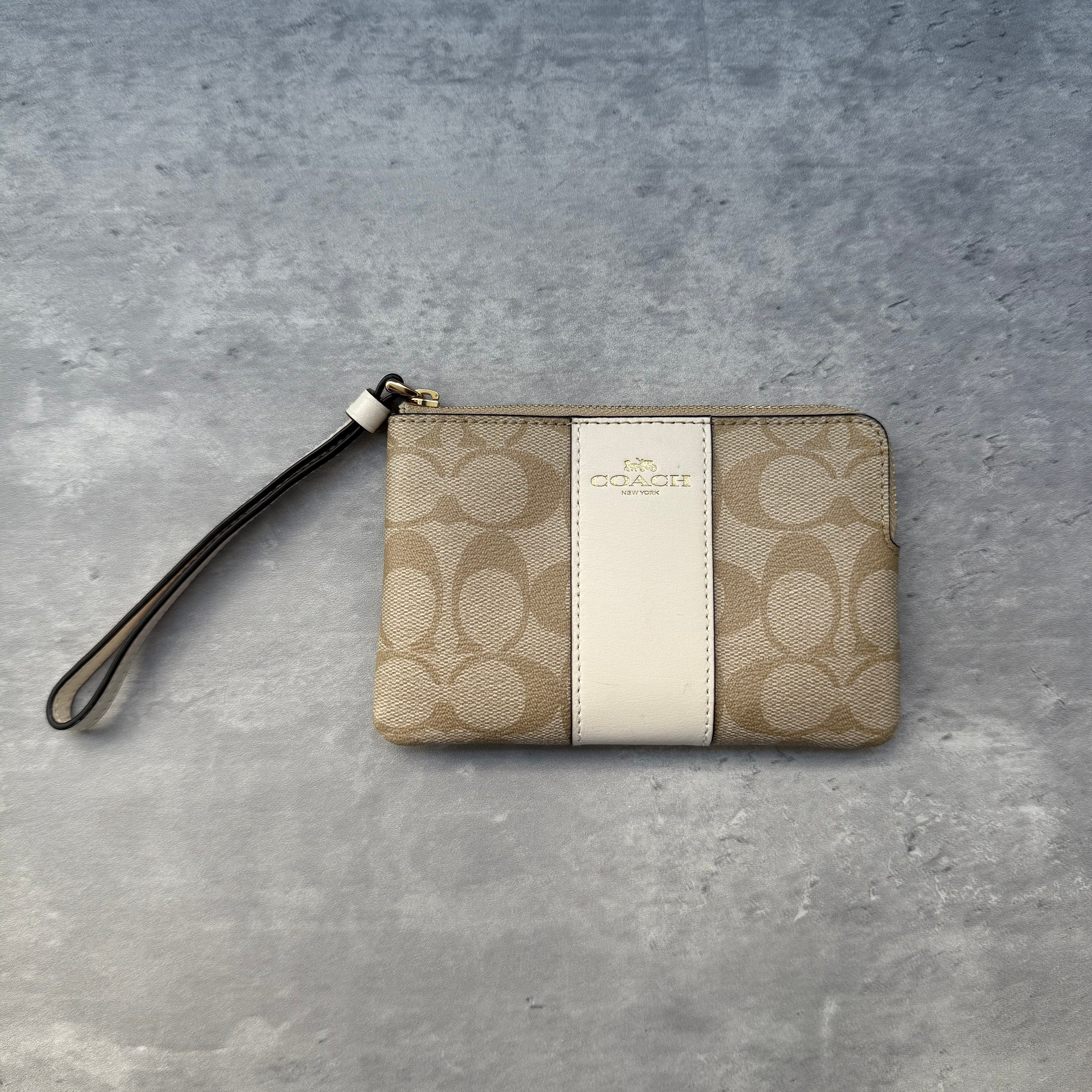 Coach Corner Zip Wristlet Light Khaki/White in signature coated canvas with white leather stripe and gold-tone hardware, interior card slots, and detachable wrist strap.