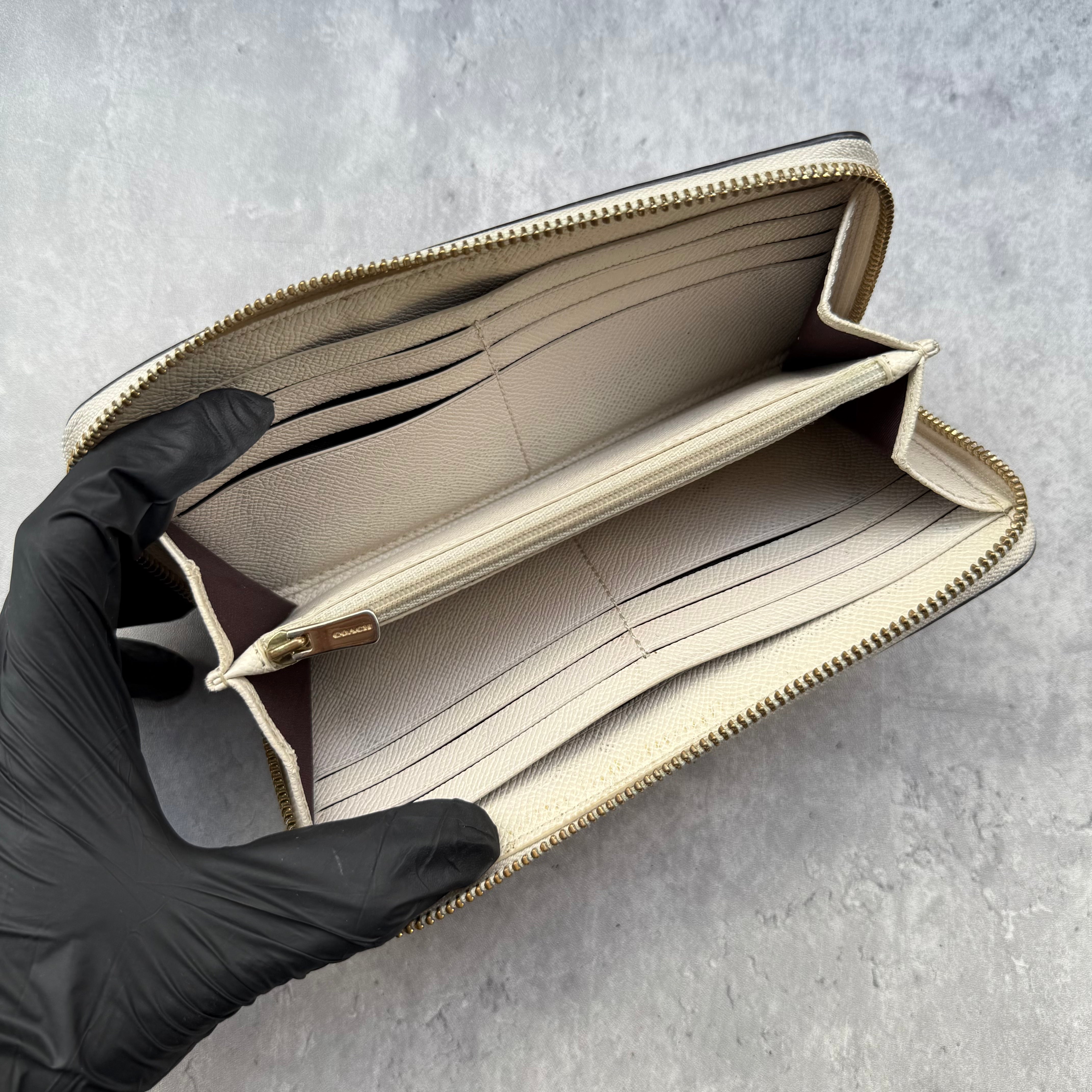 Coach Crossgrain Leather Zip Wallet Chalk White, featuring a zip-around design, external pocket, and gold-tone logo.