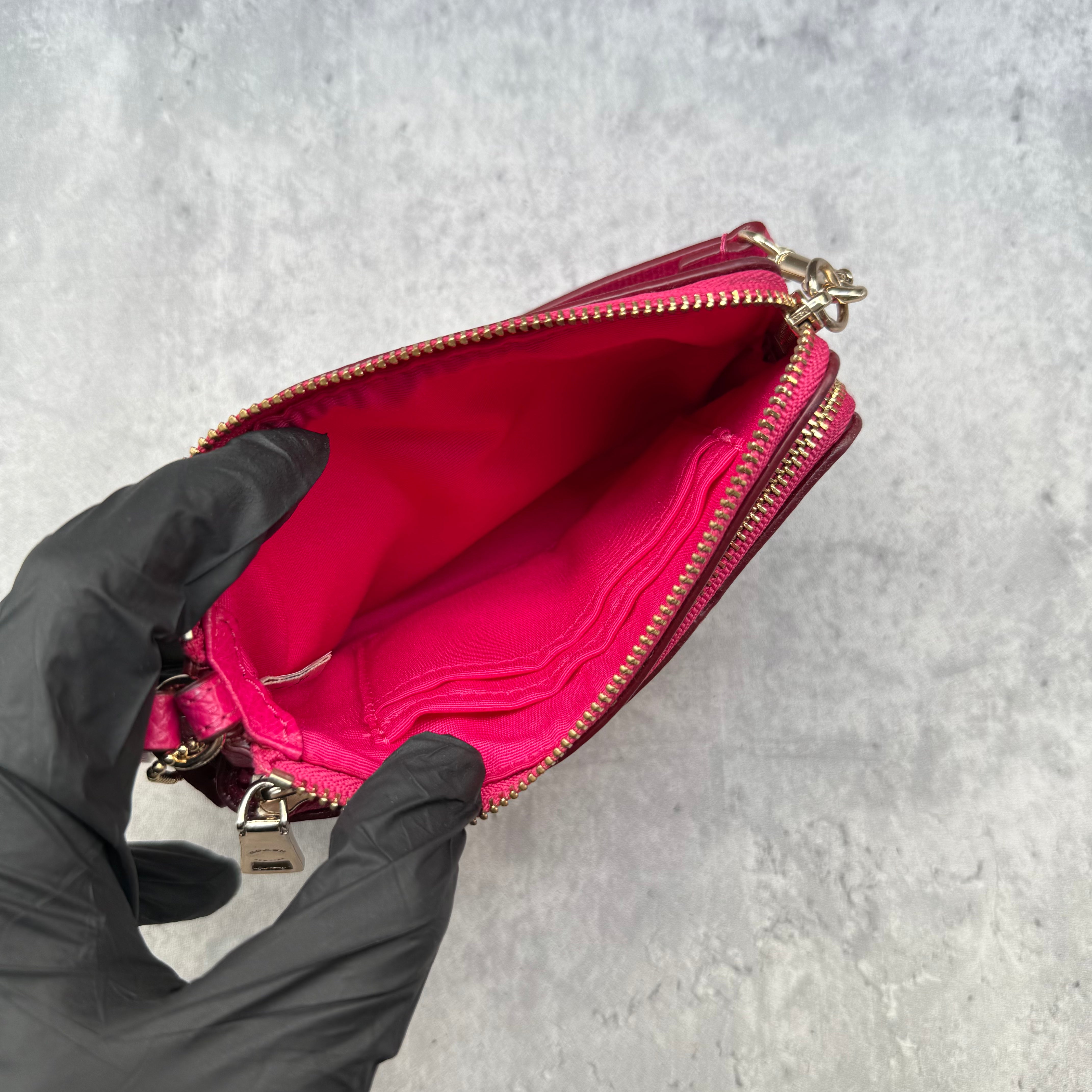 Coach Double Corner Zip Wristlet Pink/Beige, featuring signature coated canvas with pink leather trim and two zip compartments.