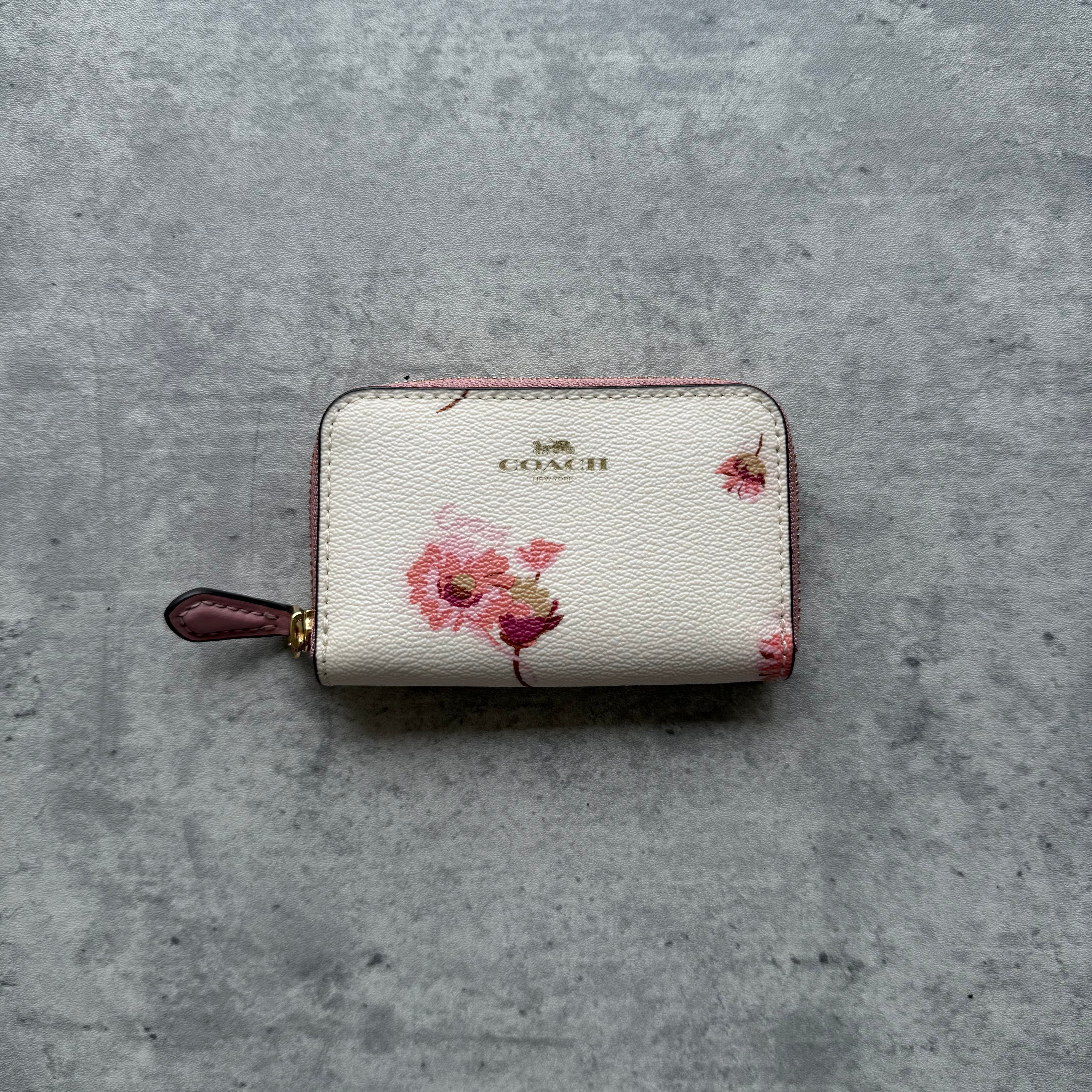 Coach Essential Small Zip Around Card Case in white pebbled leather with floral print and pink interior.