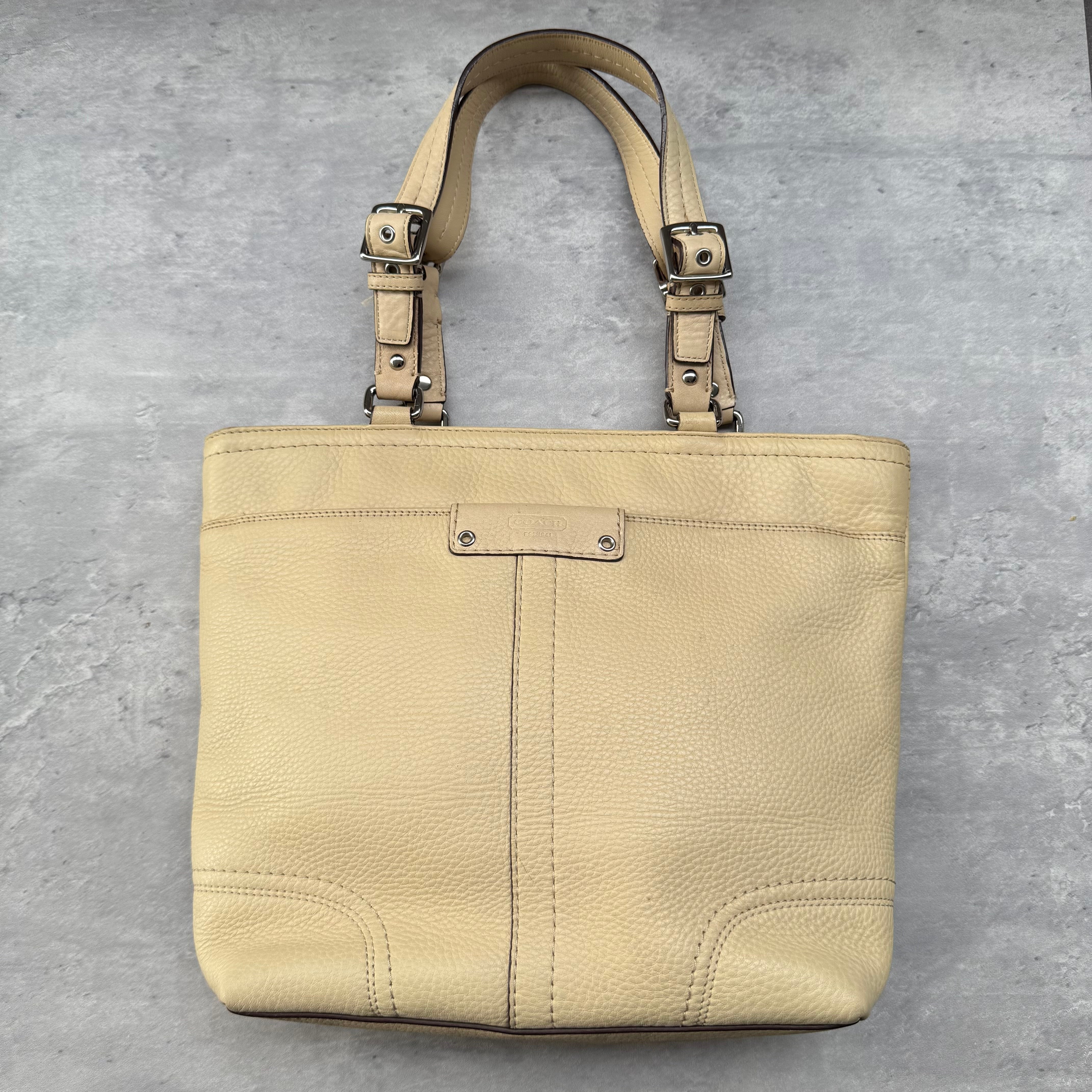 Coach Hamilton Tote Bag in cream pebbled leather with silver-tone hardware, adjustable buckle straps, and spacious interior.