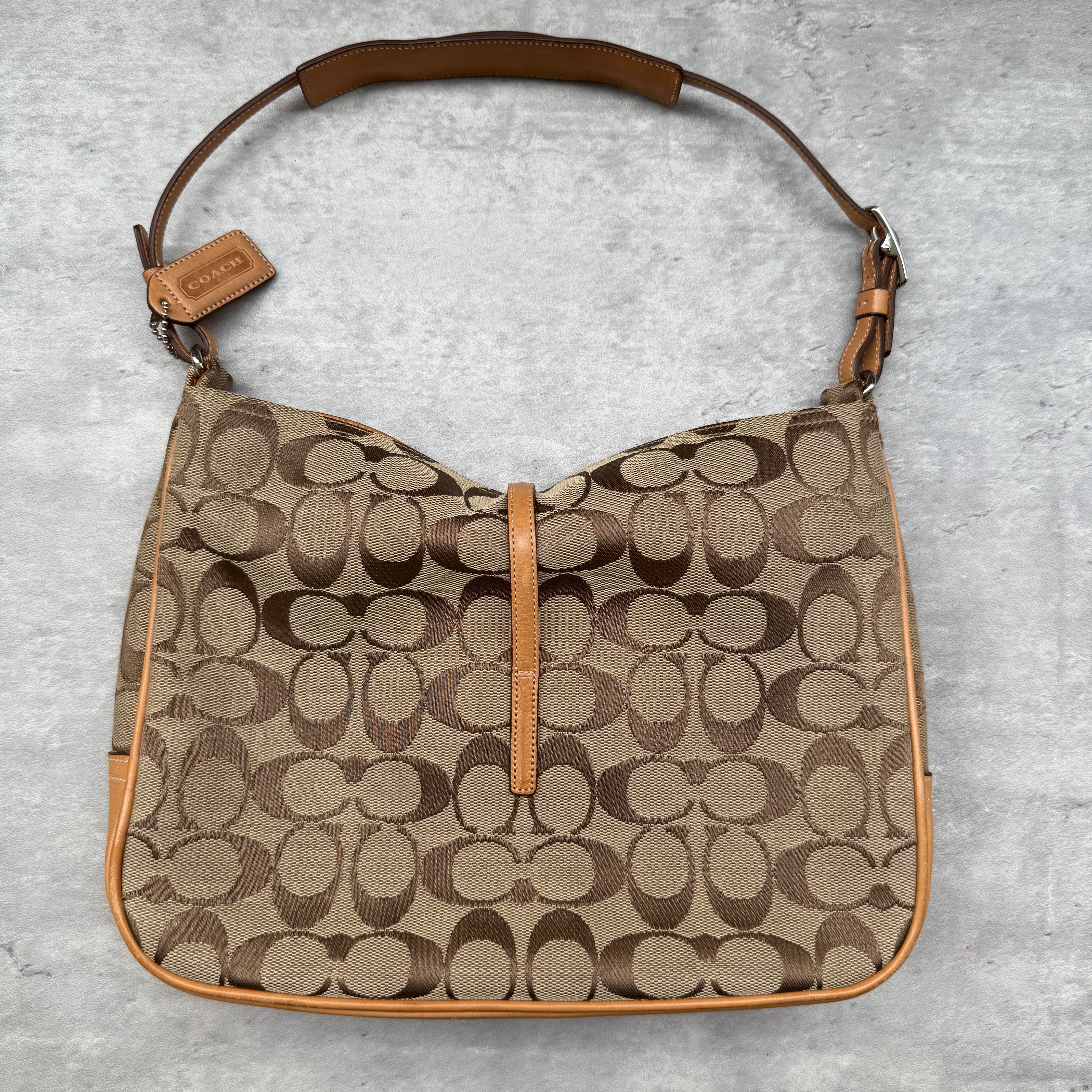 Coach Hobo Signature Clip Canvas Handbag Beige with monogram jacquard canvas, tan leather trim, front clip accent, and red-orange interior lining
