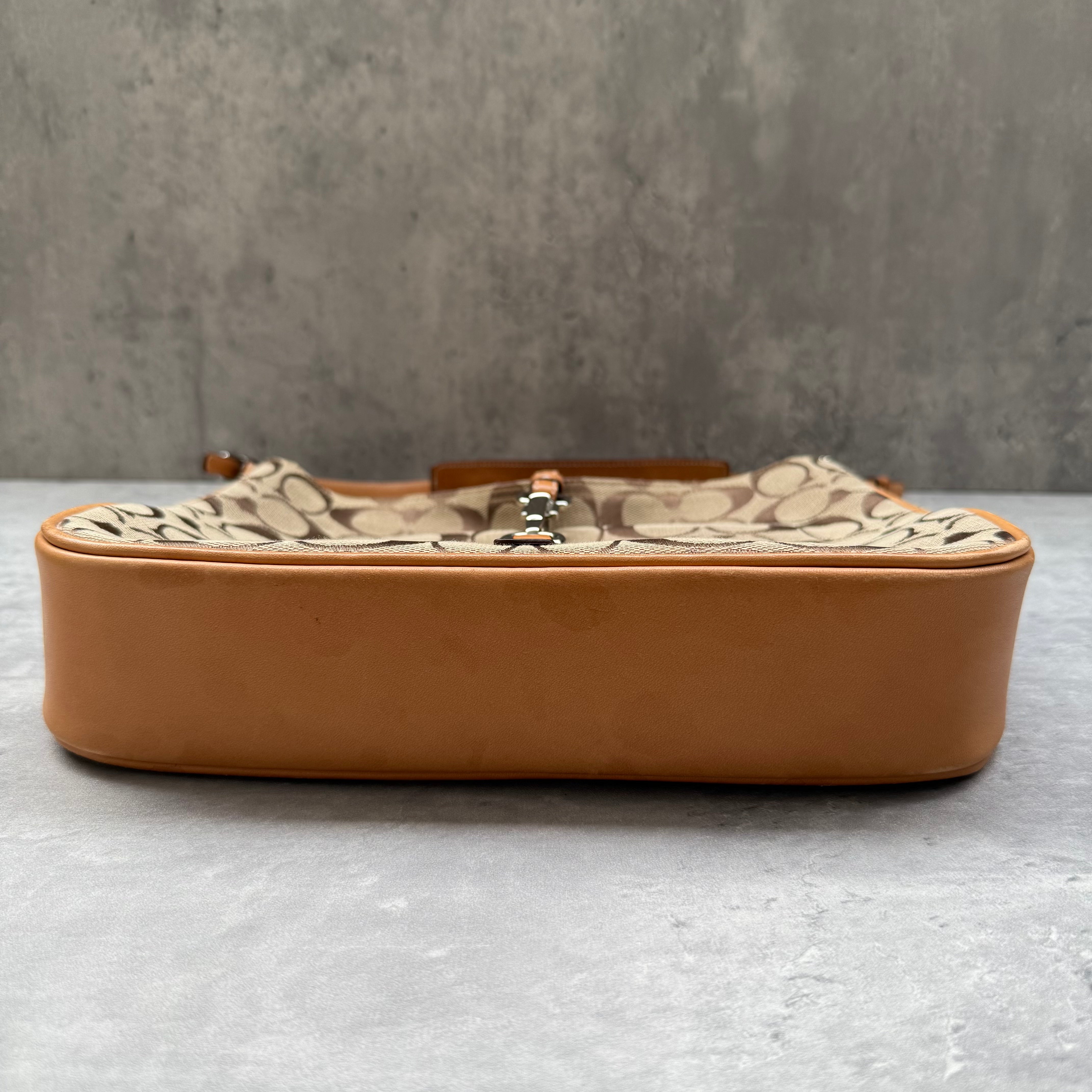 Coach Hobo Signature Clip Canvas Handbag Beige with monogram jacquard canvas, tan leather trim, front clip accent, and red-orange interior lining