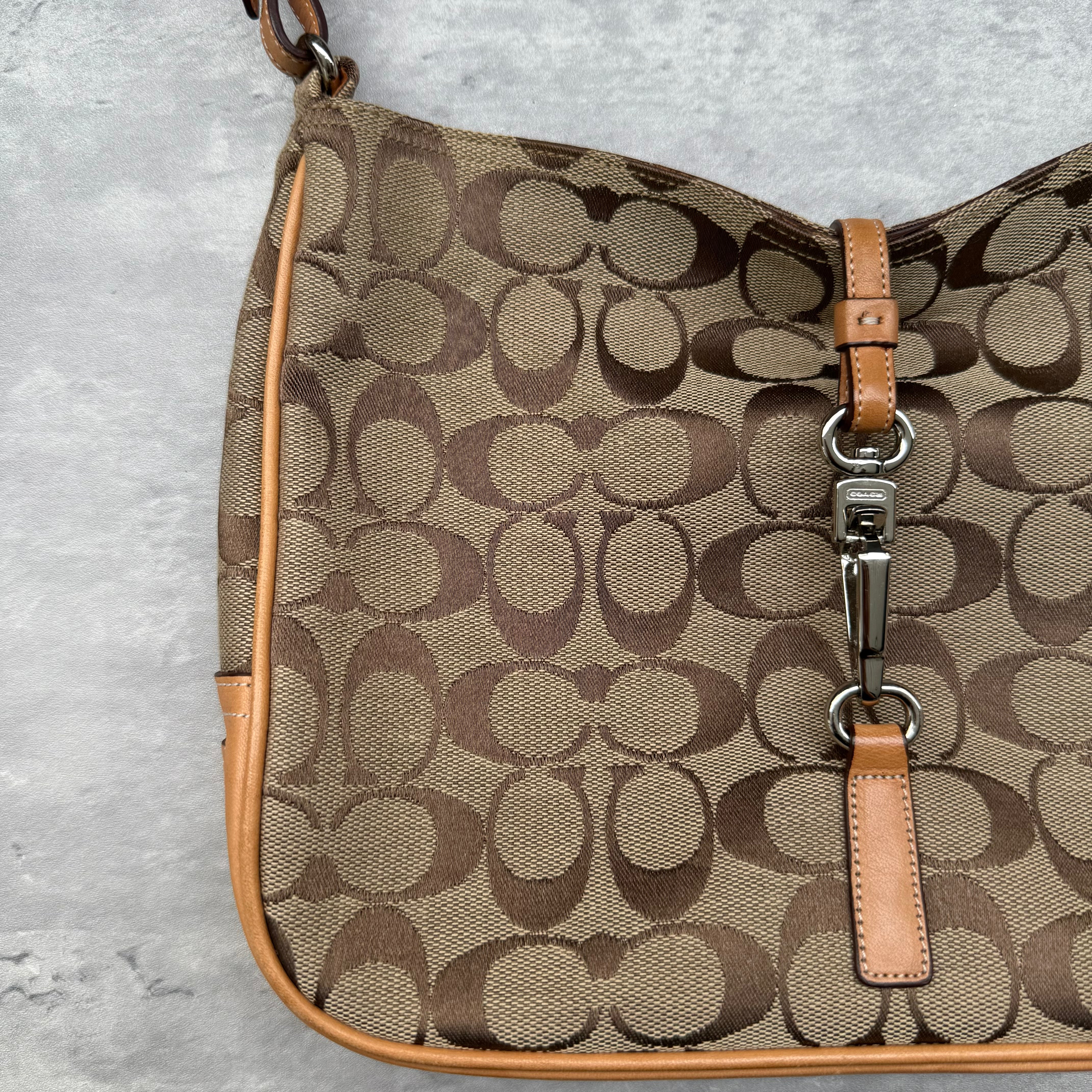 Coach Hobo Signature Clip Canvas Handbag Beige with monogram jacquard canvas, tan leather trim, front clip accent, and red-orange interior lining
