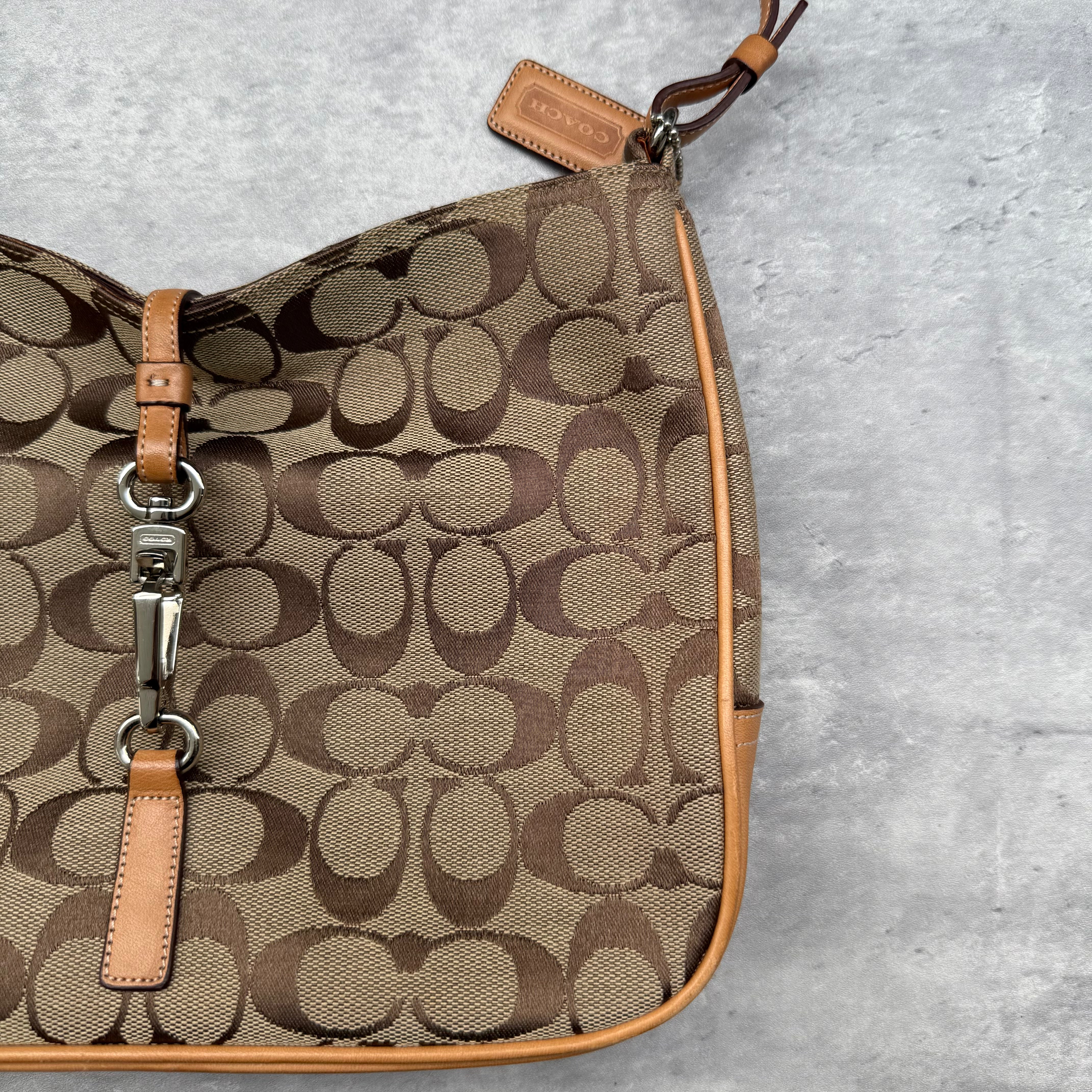Coach Hobo Signature Clip Canvas Handbag Beige with monogram jacquard canvas, tan leather trim, front clip accent, and red-orange interior lining