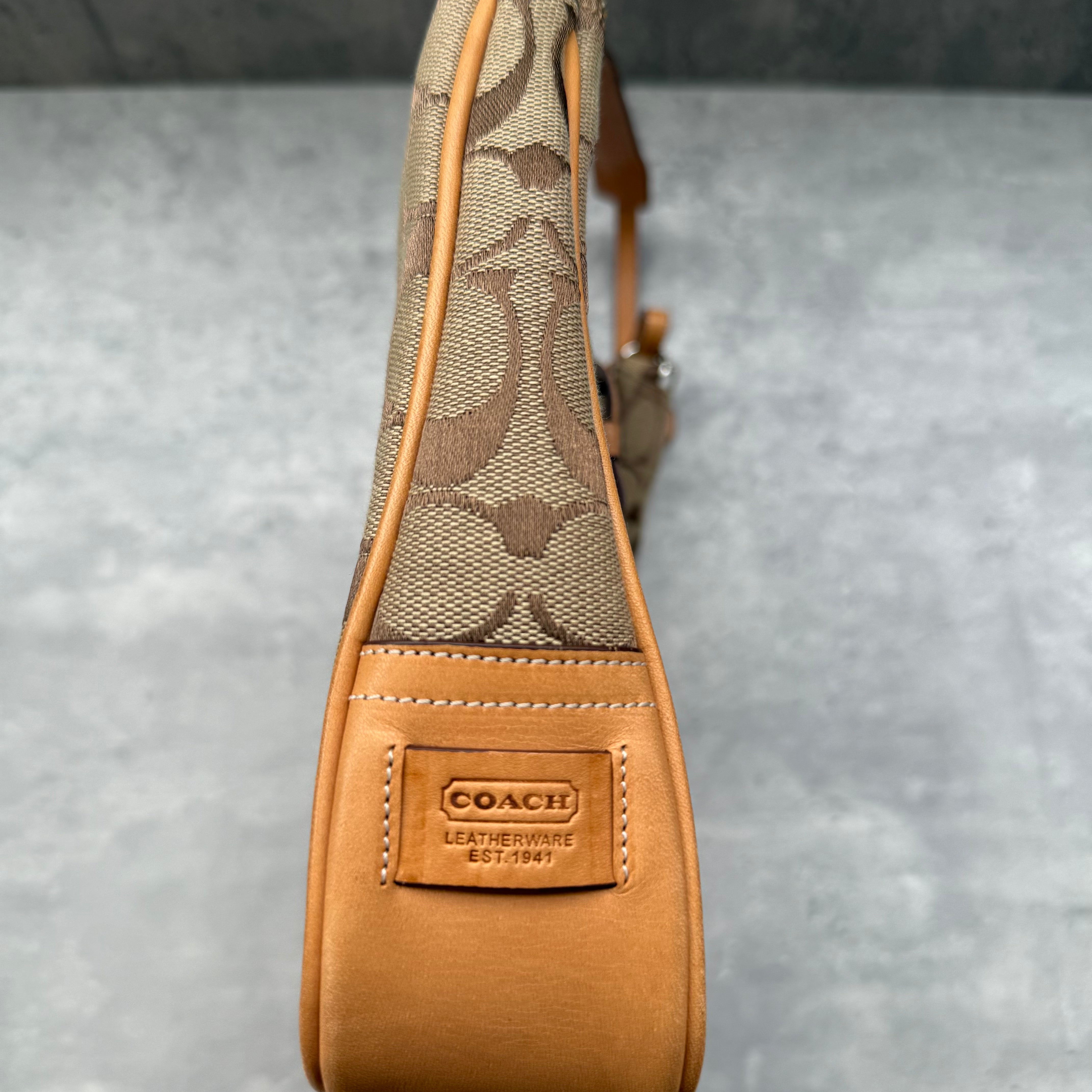 Coach Hobo Signature Clip Canvas Handbag Beige with monogram jacquard canvas, tan leather trim, front clip accent, and red-orange interior lining