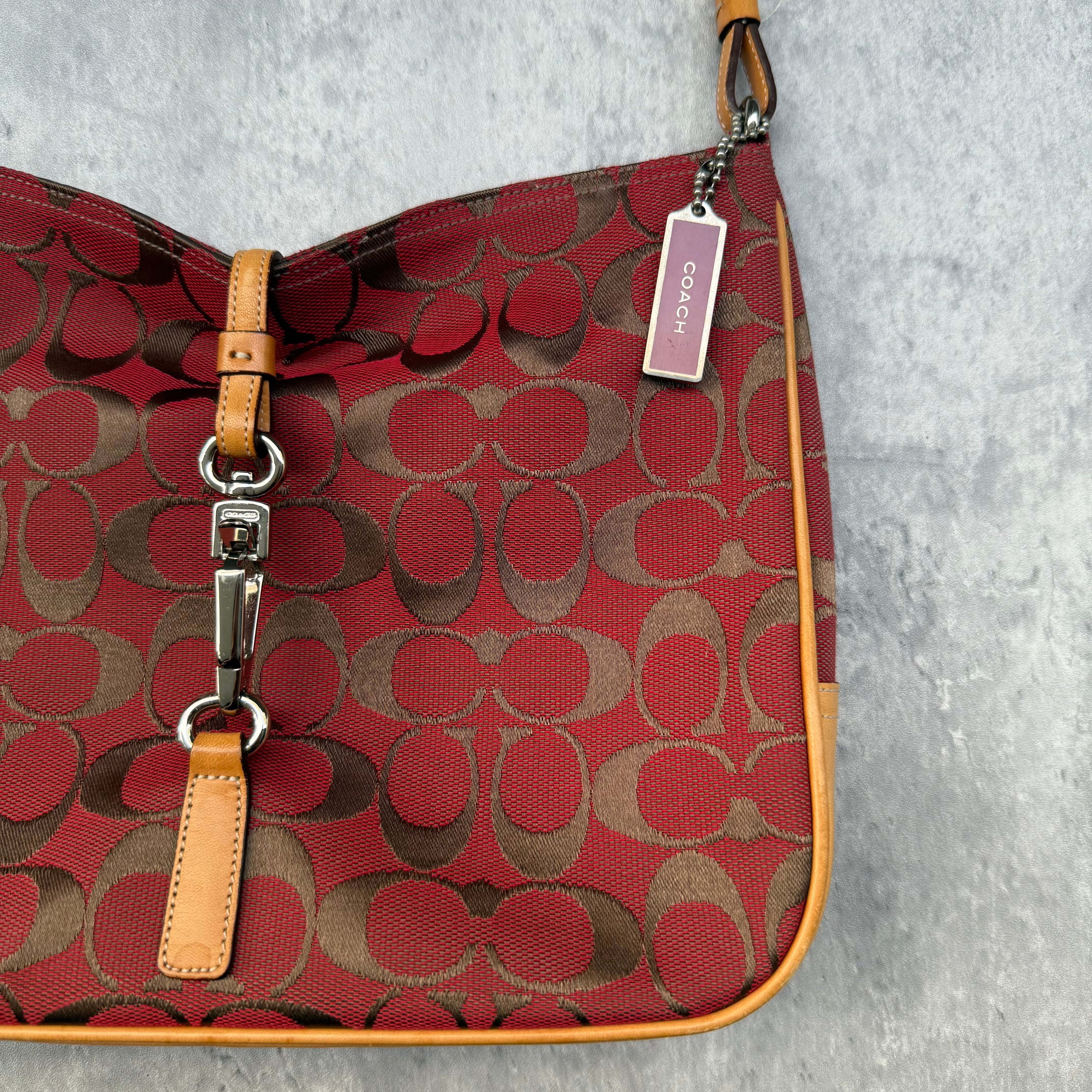 Coach Hobo Signature Clip Canvas Handbag in red monogram canvas with beige leather trim, front clip detail, and beige interior.