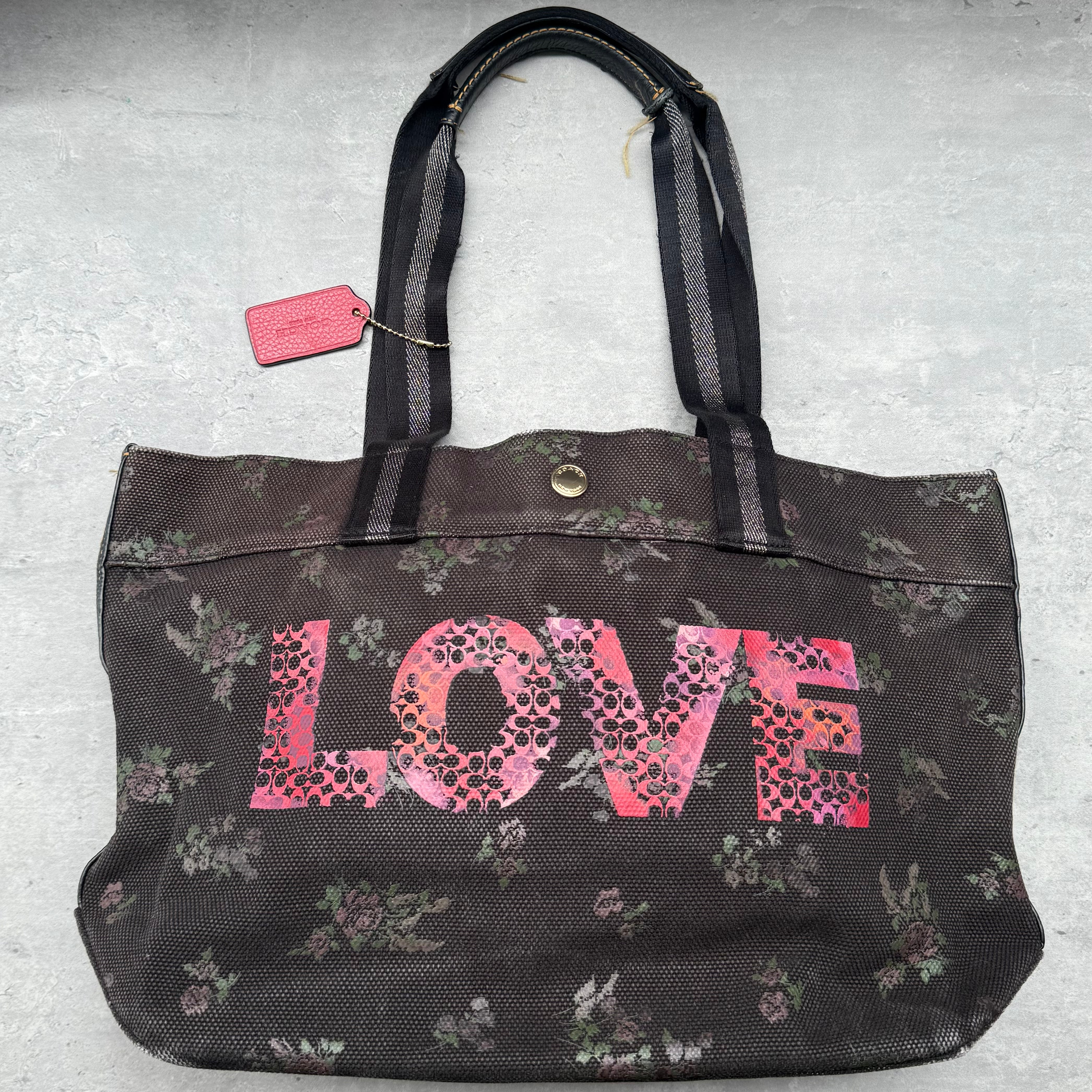 Coach Jason Naylor LOVE Graphic Tote Bag in brown floral canvas with pink LOVE print and gold-tone hardware.