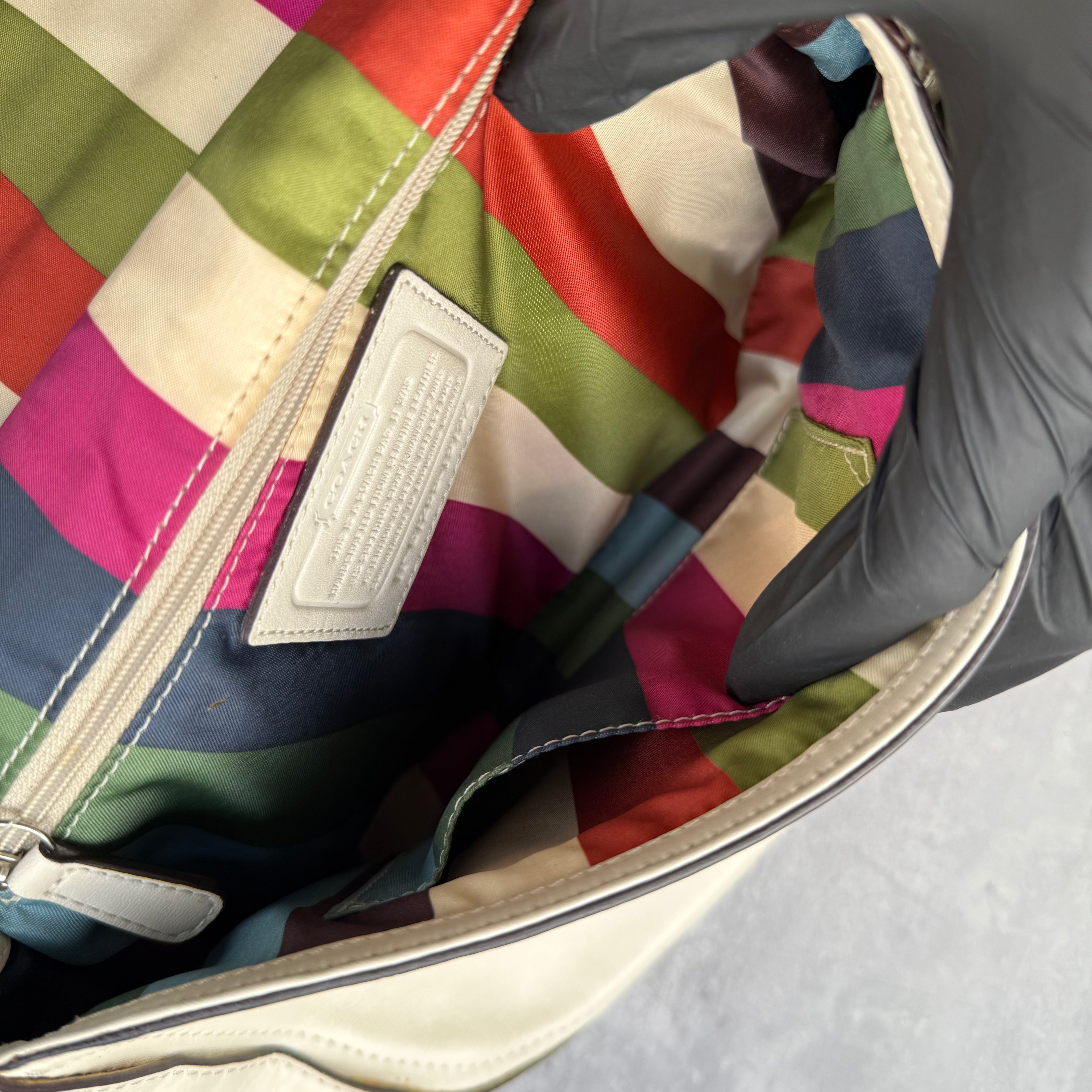 Coach Legacy Willis Tassel Handbag White with top handle, extra crossbody strap, and striped interior lining