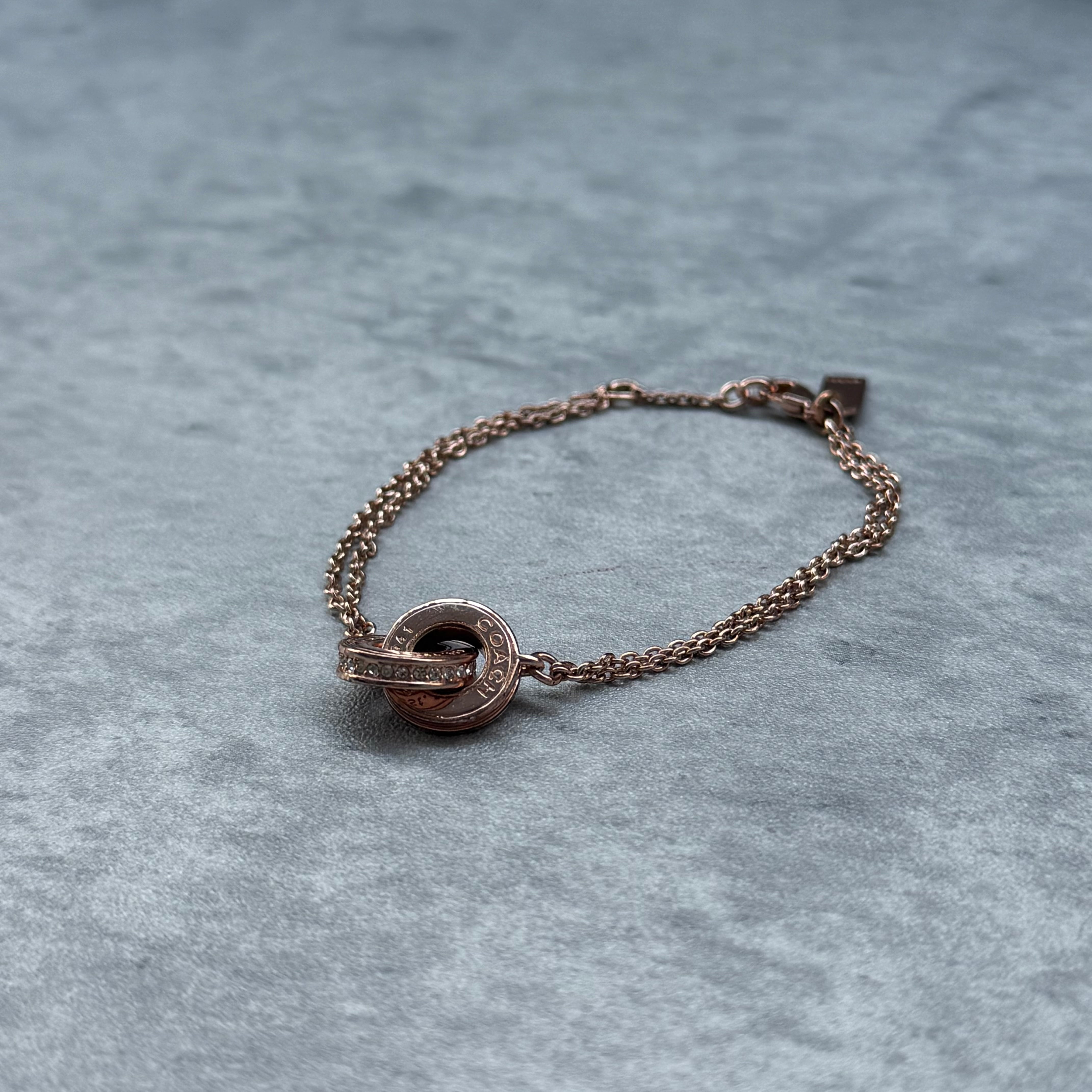 Coach Linked Rondelle Double Chain Bracelet Rose Gold, featuring interlocking logo and crystal rondelle charms on double chain.