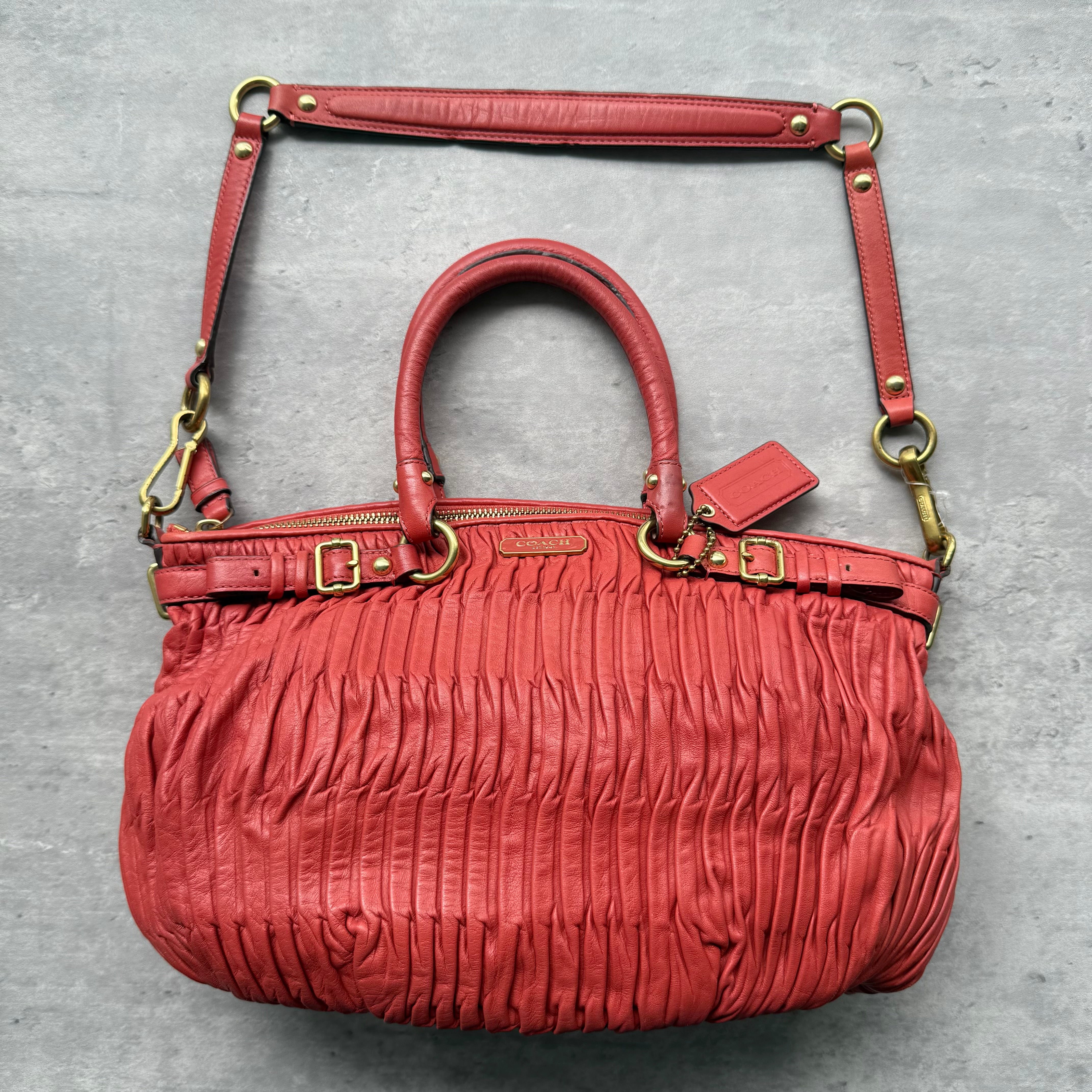 Coach Madison 2Way Shoulder Bag in red pleated leather with gold-tone hardware, rolled handles, and detachable strap.