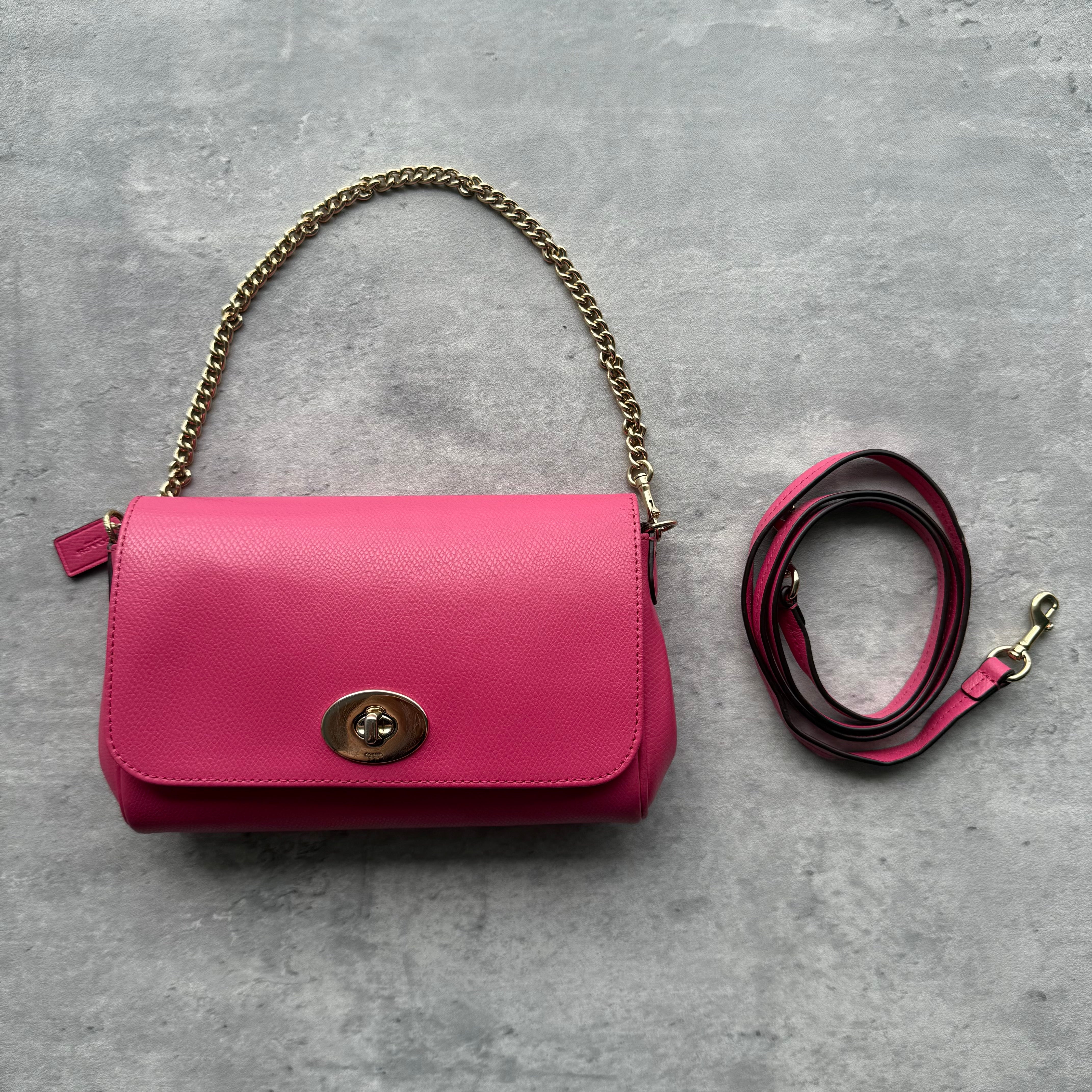 Coach Mini Ruby Crossbody Bag in pink leather with gold-tone hardware, turn-lock closure, chain handle, and detachable crossbody strap.