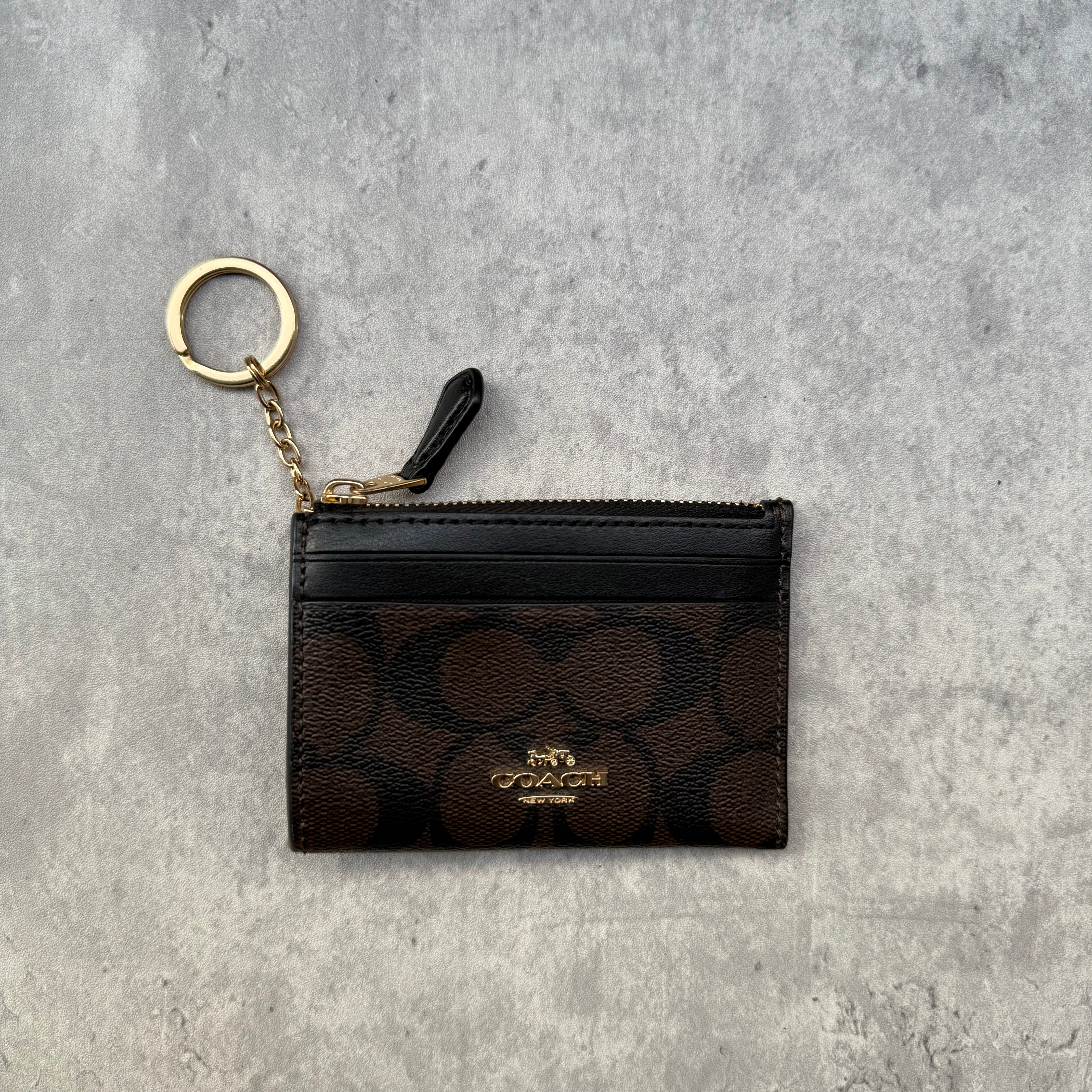 Coach Mini Skinny ID Cardholder in signature canvas with gold keyring, zip closure, and exterior ID window