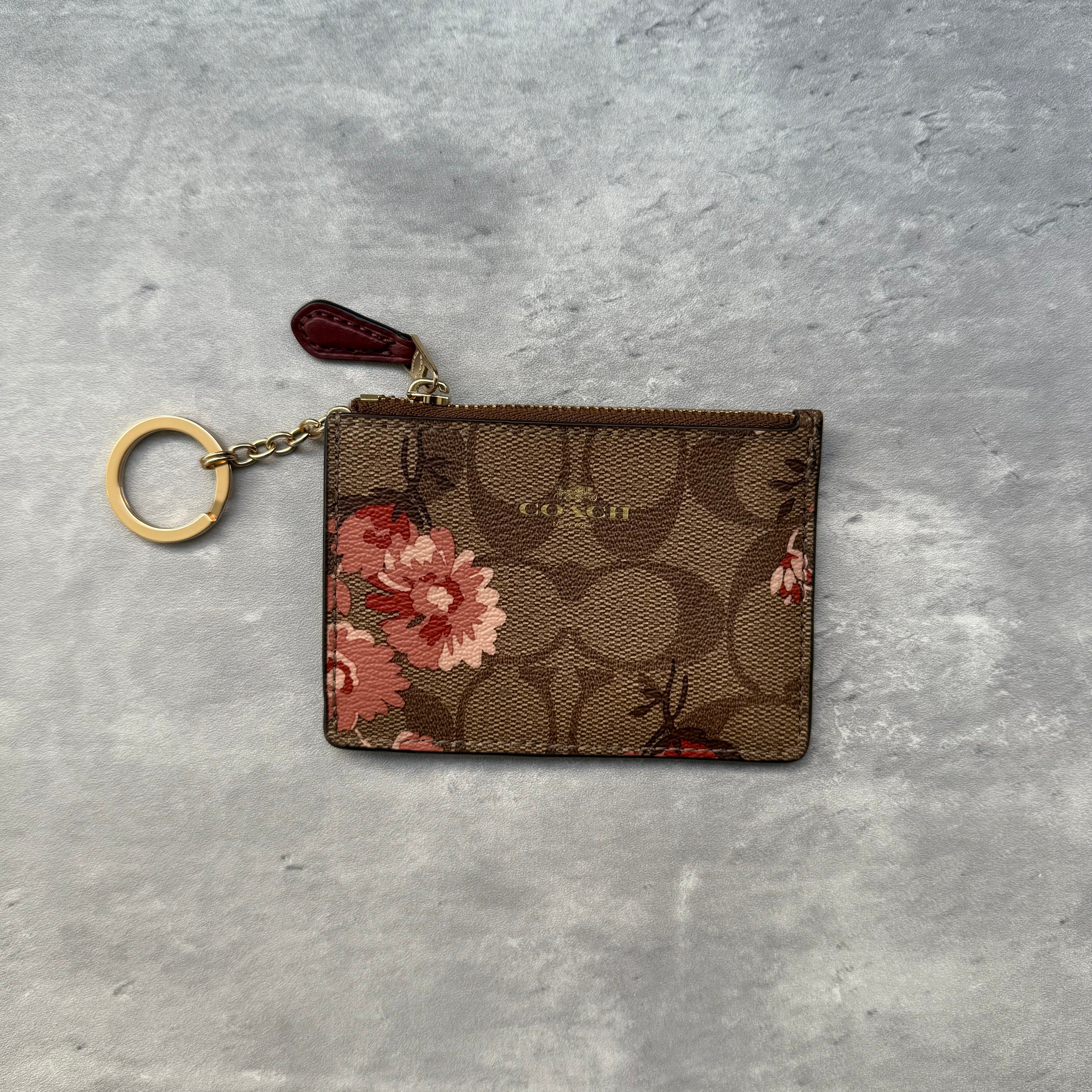 Coach Mini Skinny ID Key Cardholder Beige with peony floral print, featuring zip closure, ID window, card slots, and key ring.