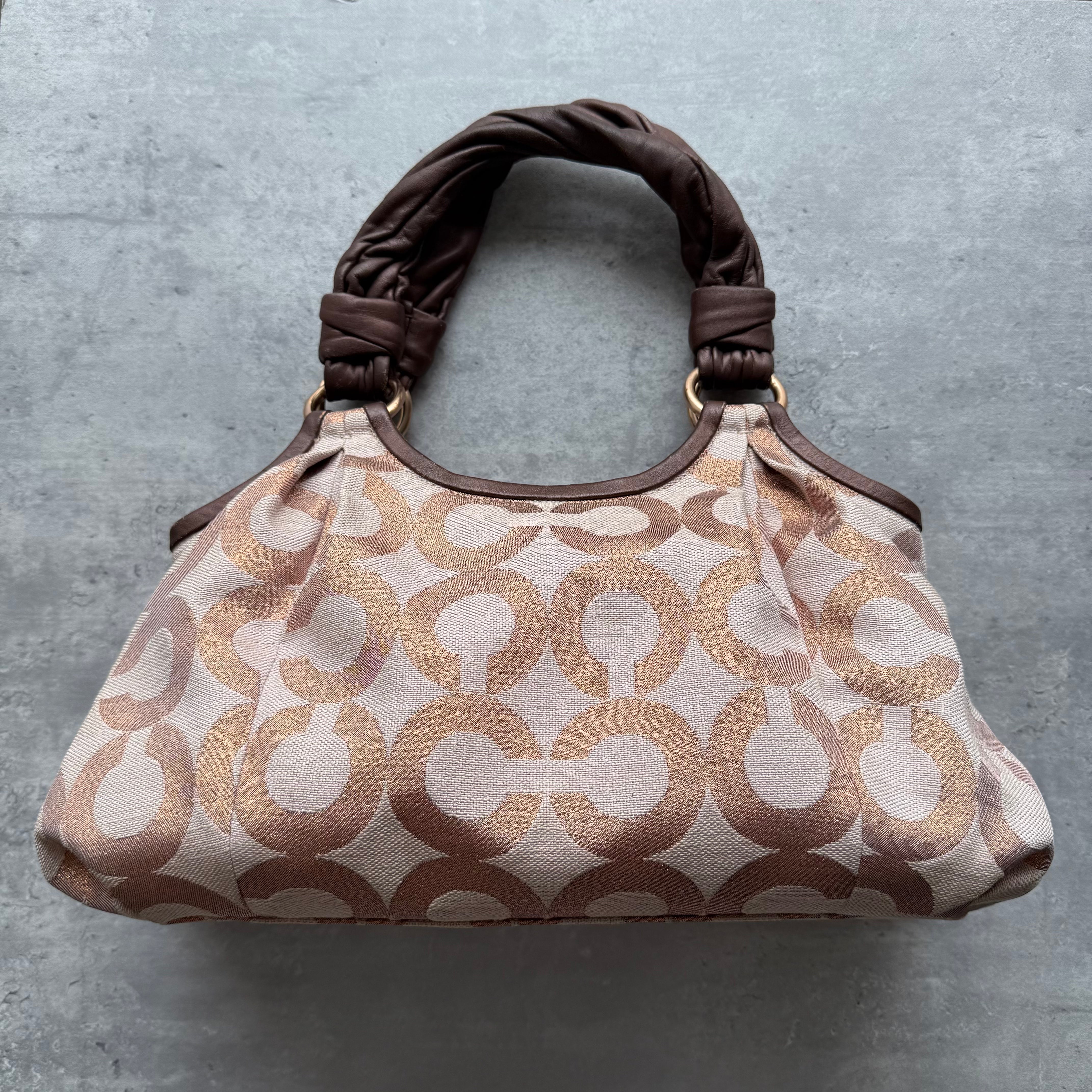 Coach Parker Op Art Shoulder Bag in brown and beige with twisted fabric handles and spacious interior.