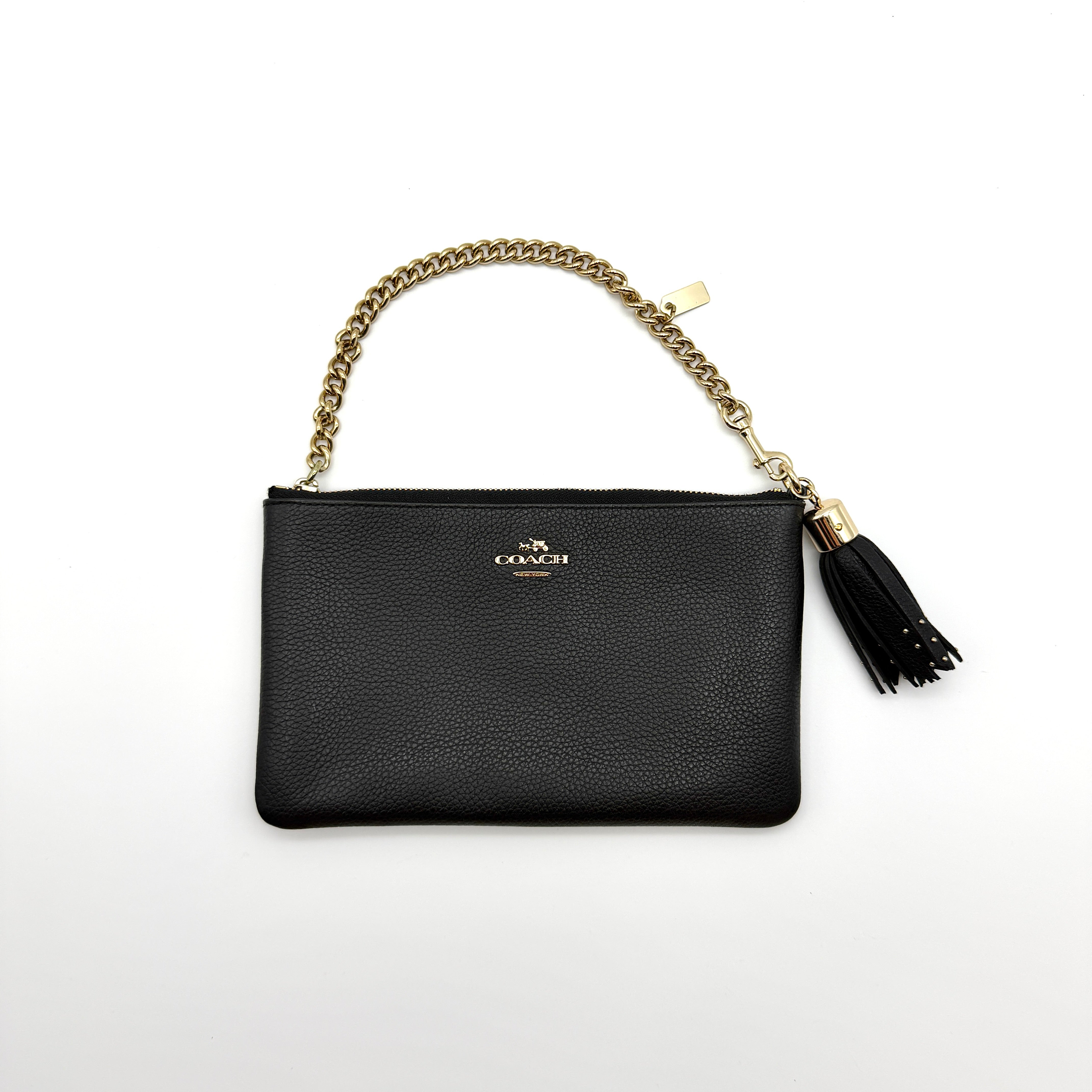 Coach Pebble Nolita 19 Shoulder Bag in black pebbled leather with gold-tone chain strap and tassel charm — pre-loved.