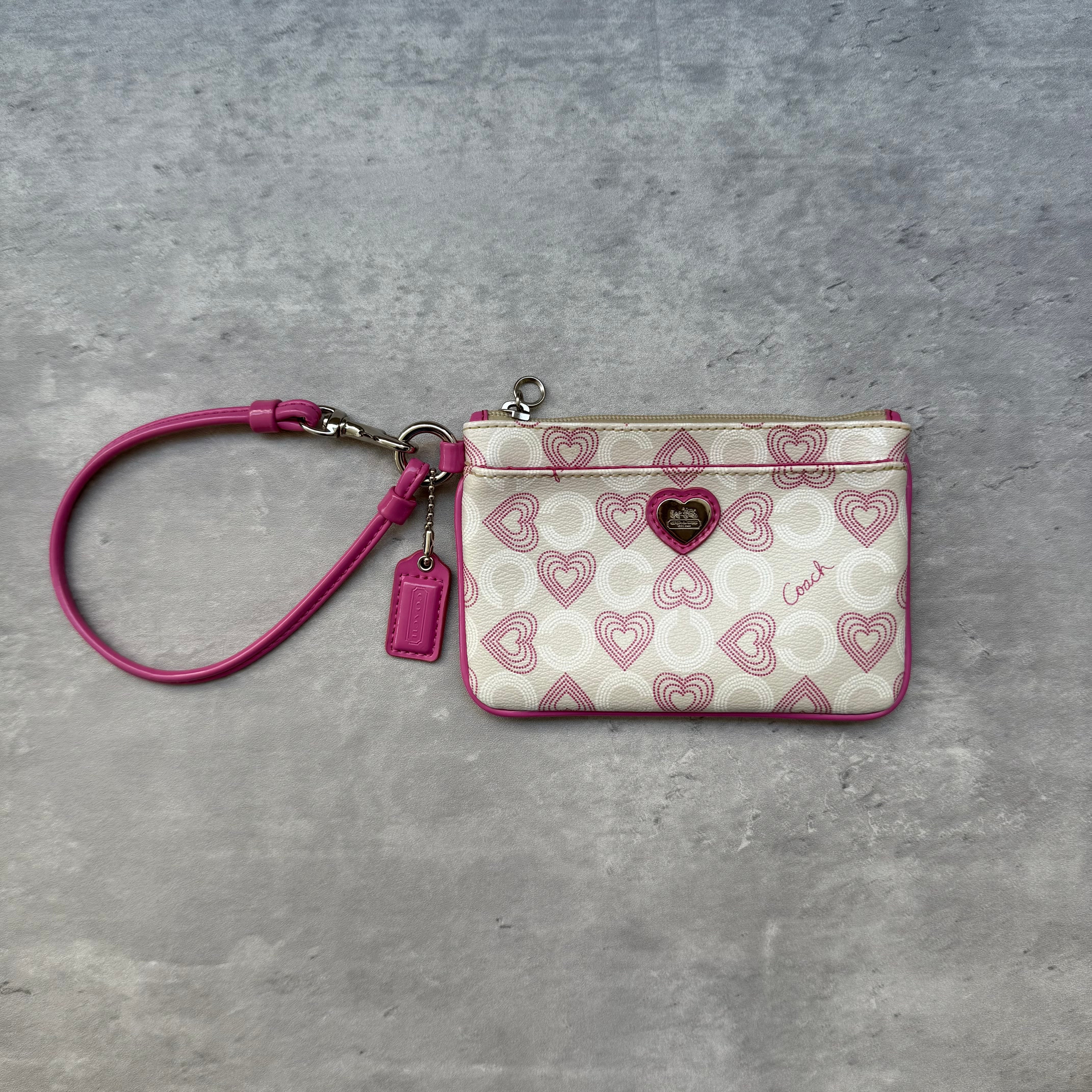 Coach Pink Heart Coin Case Wristlet in beige jacquard canvas with pink heart motifs, leather trim, and detachable wrist strap.
