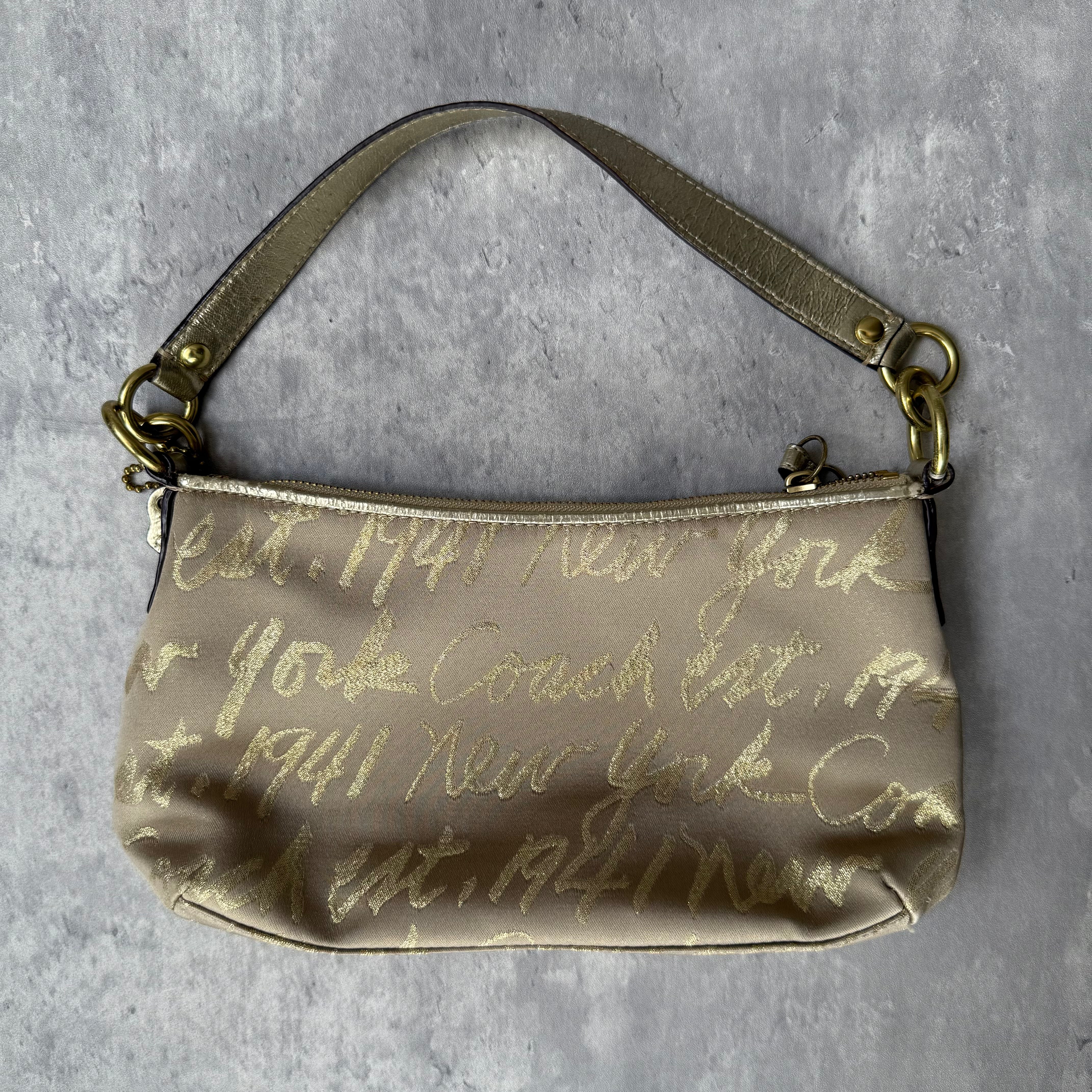 Coach Script Heart Shoulder Bag in beige satin with crystal heart charm, lavender interior, and gold-tone hardware.