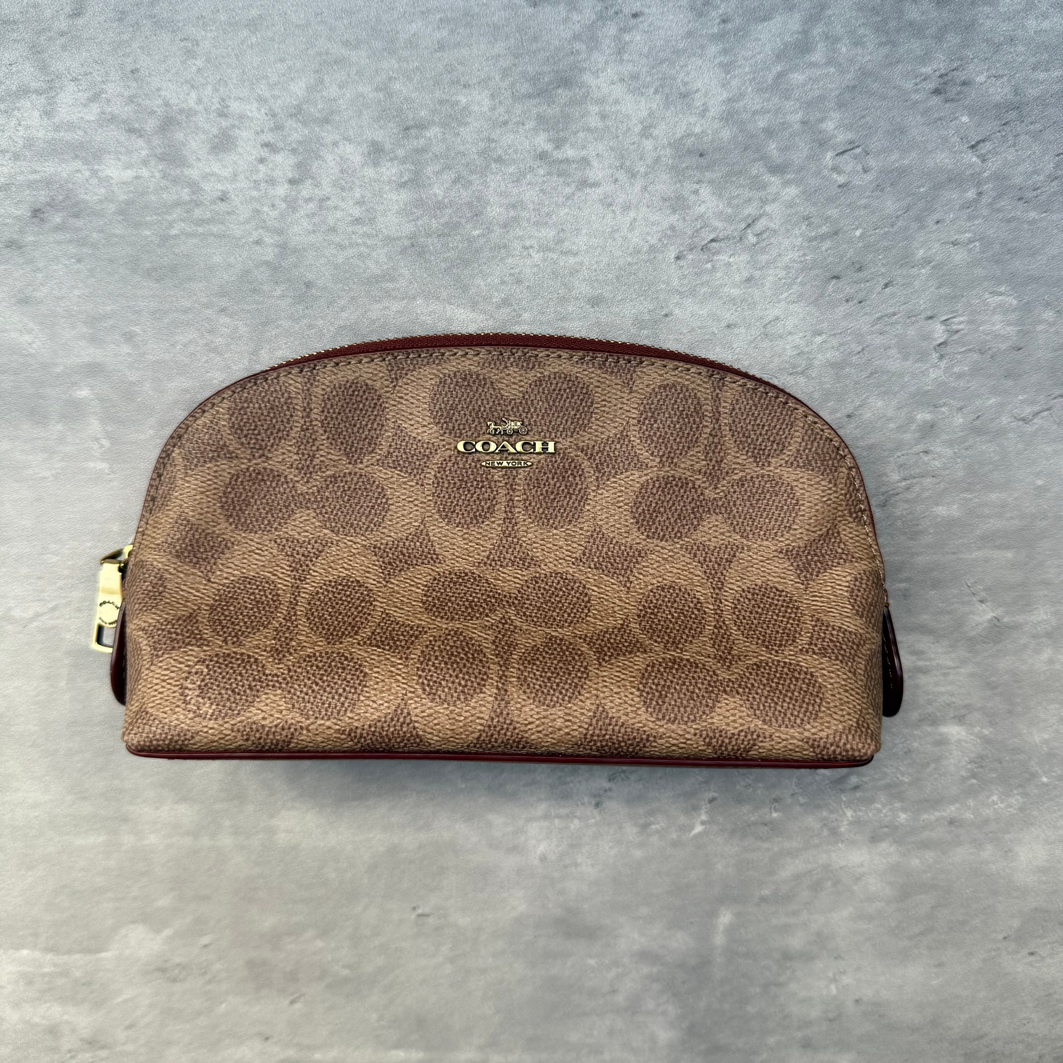 Coach Signature Canvas Cosmetic Case Beige, coated canvas with burgundy leather trim and gold-tone hardware, zip-around closure.