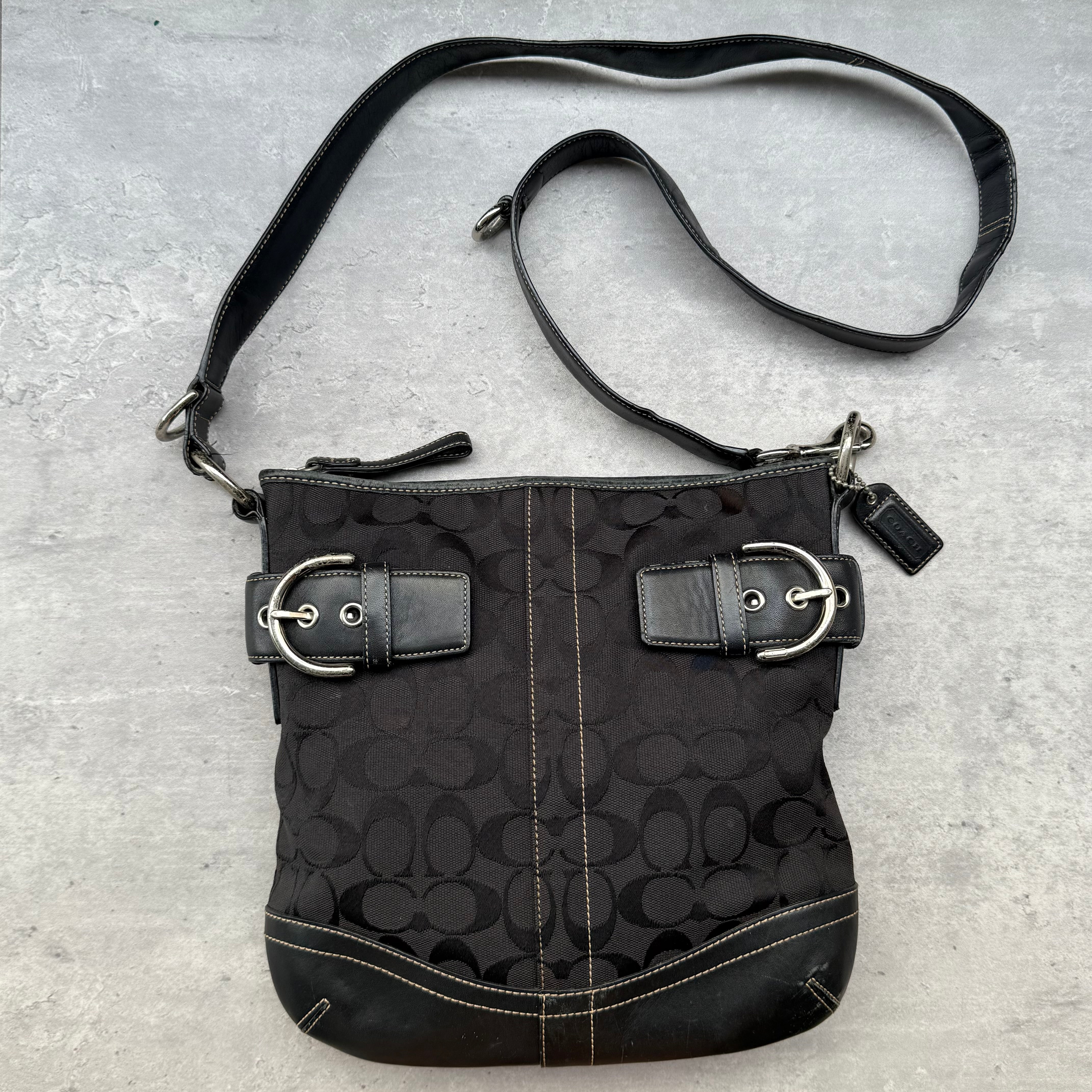 Coach Signature Canvas Crossbody Bag Black with silver-tone buckle accents and leather trim, featuring zip-top closure and adjustable strap.