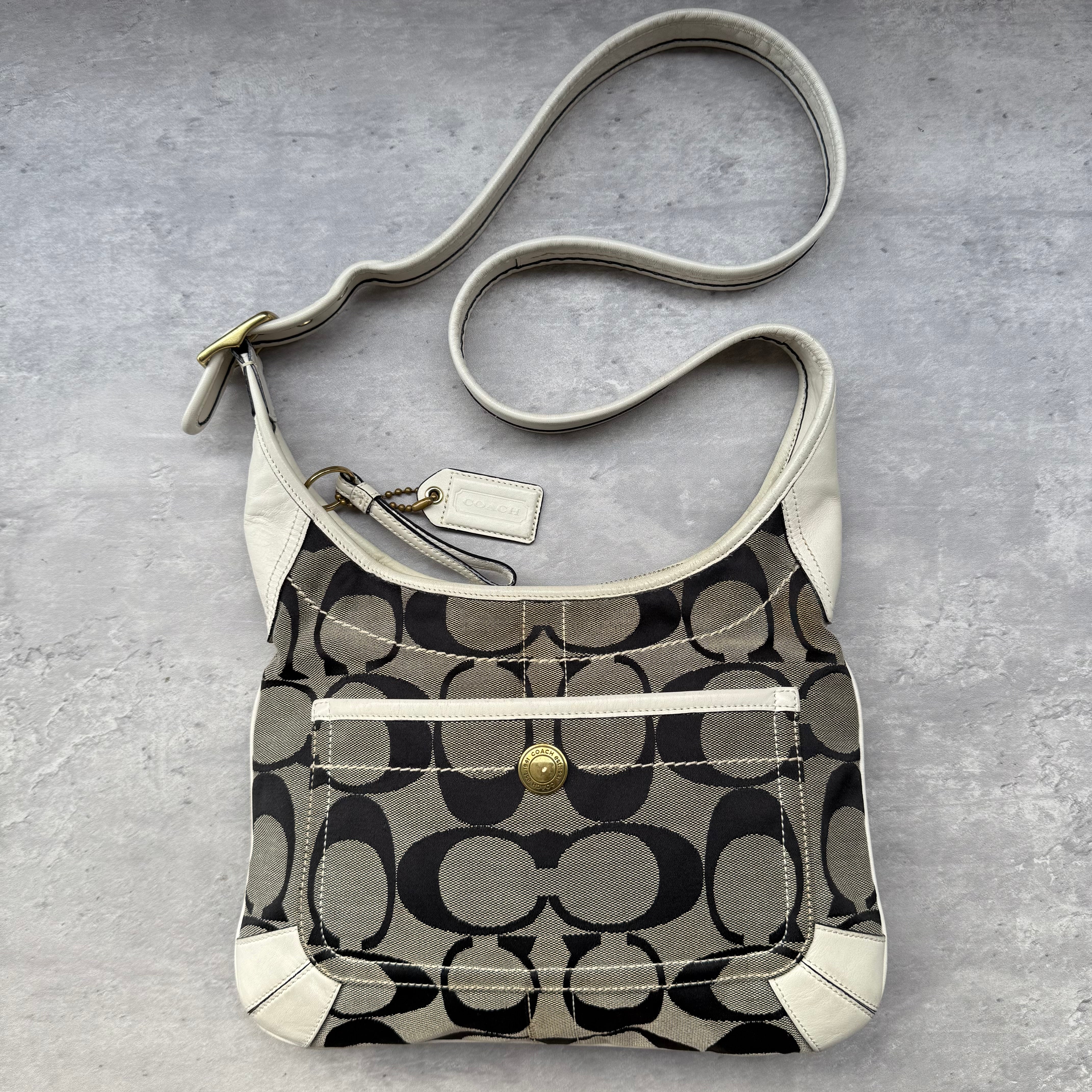 Coach Signature Canvas Hobo Crossbody Grey/White, crafted from jacquard canvas with leather trim, featuring a front snap pocket and adjustable strap.