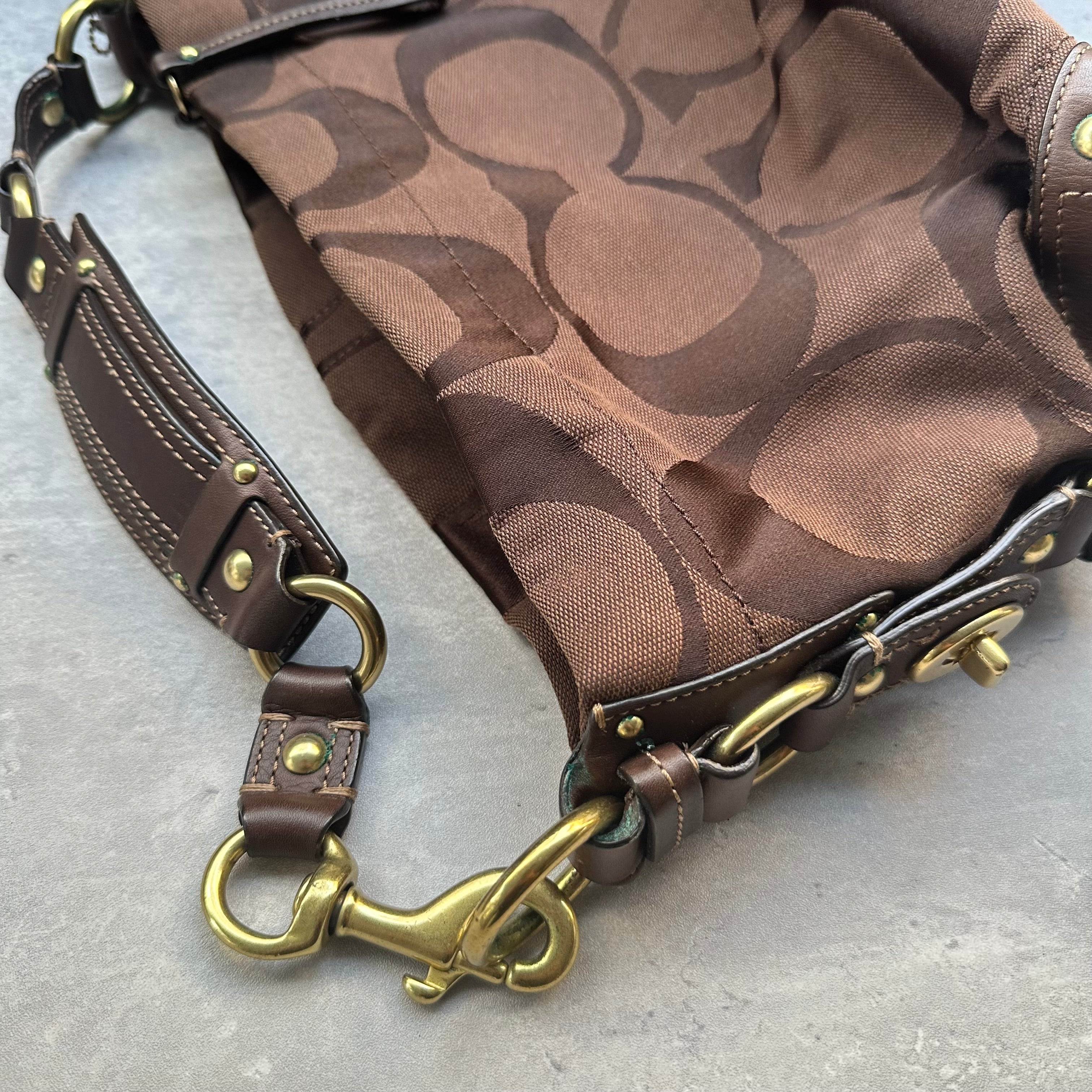 Coach Signature Canvas Hobo Shoulder Bag in brown jacquard fabric, featuring brass hardware, leather trim, and a zip-top closure.