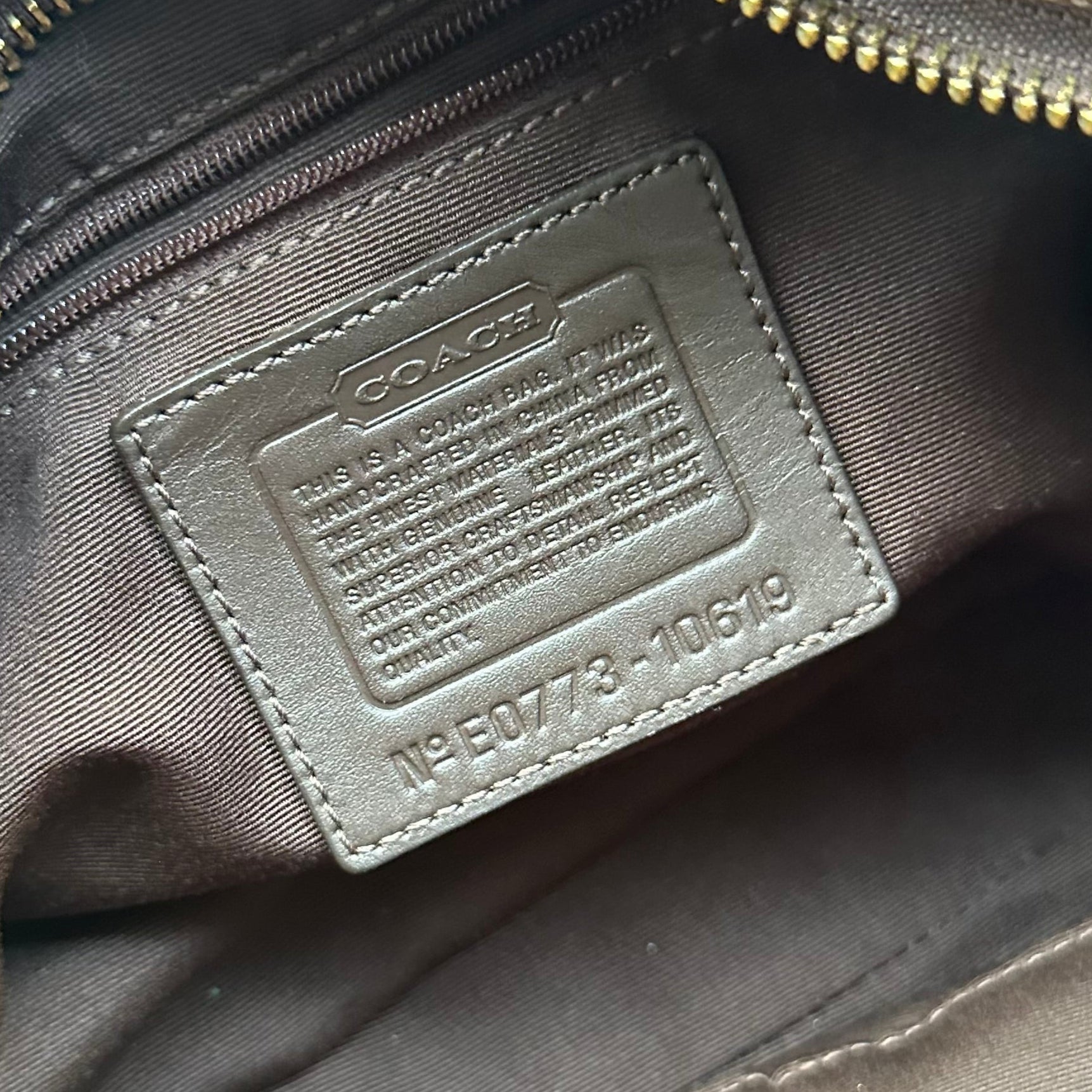 Coach Signature Canvas Hobo Shoulder Bag in brown jacquard fabric, featuring brass hardware, leather trim, and a zip-top closure.