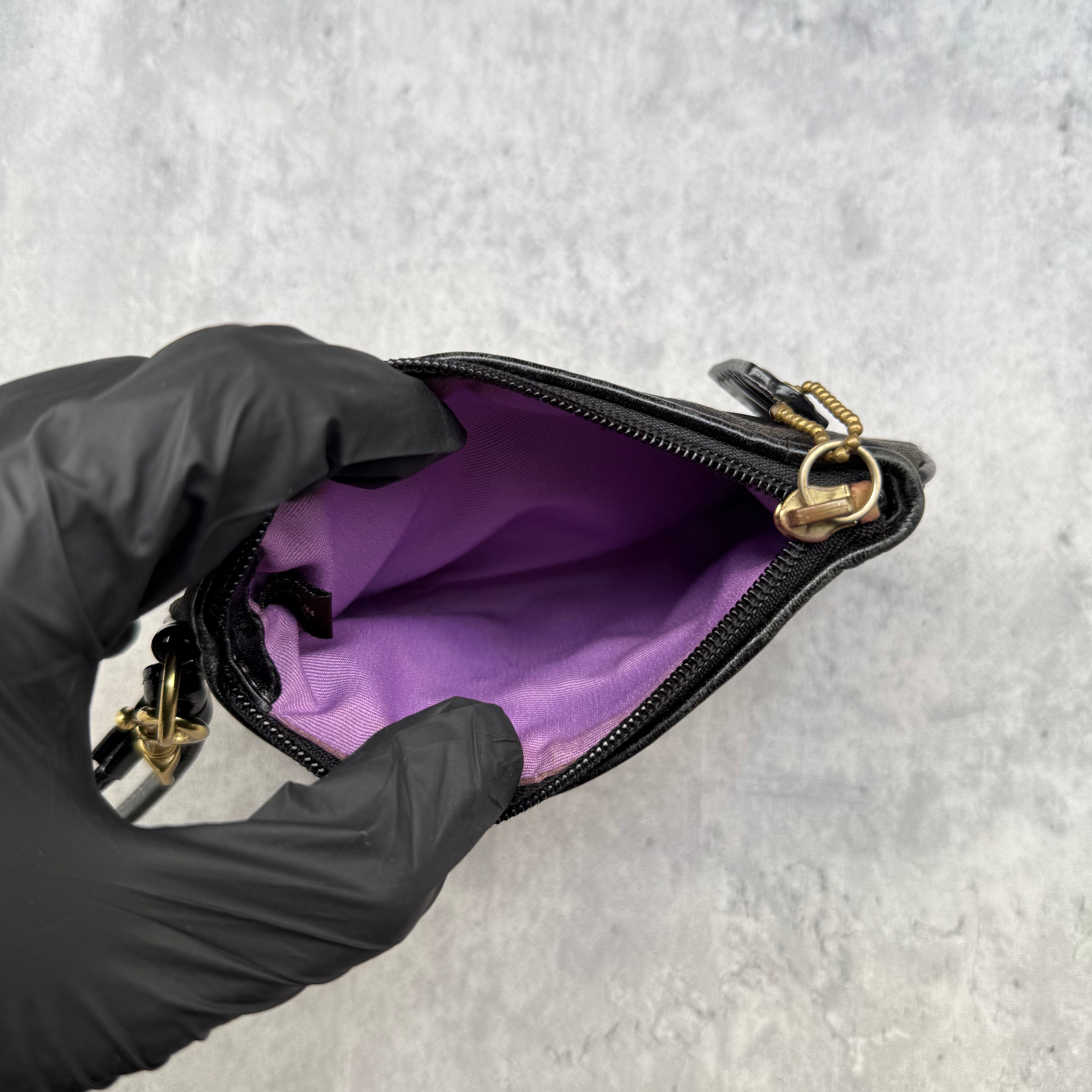 Coach Signature Canvas Wristlet Black with monogram jacquard, leather trim, and gold Coach logo plaque